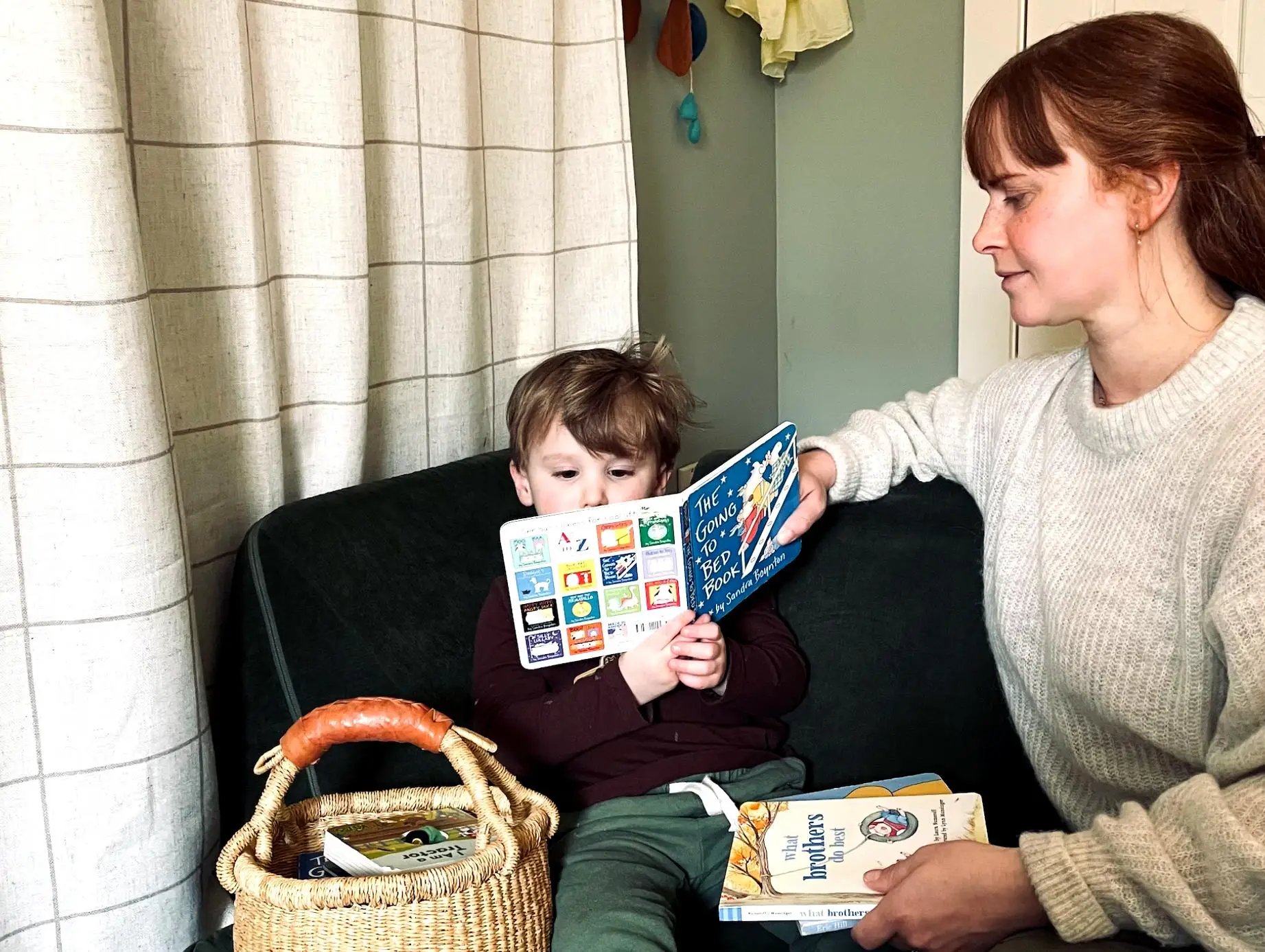 Danielle Bouchard and her son holding a book