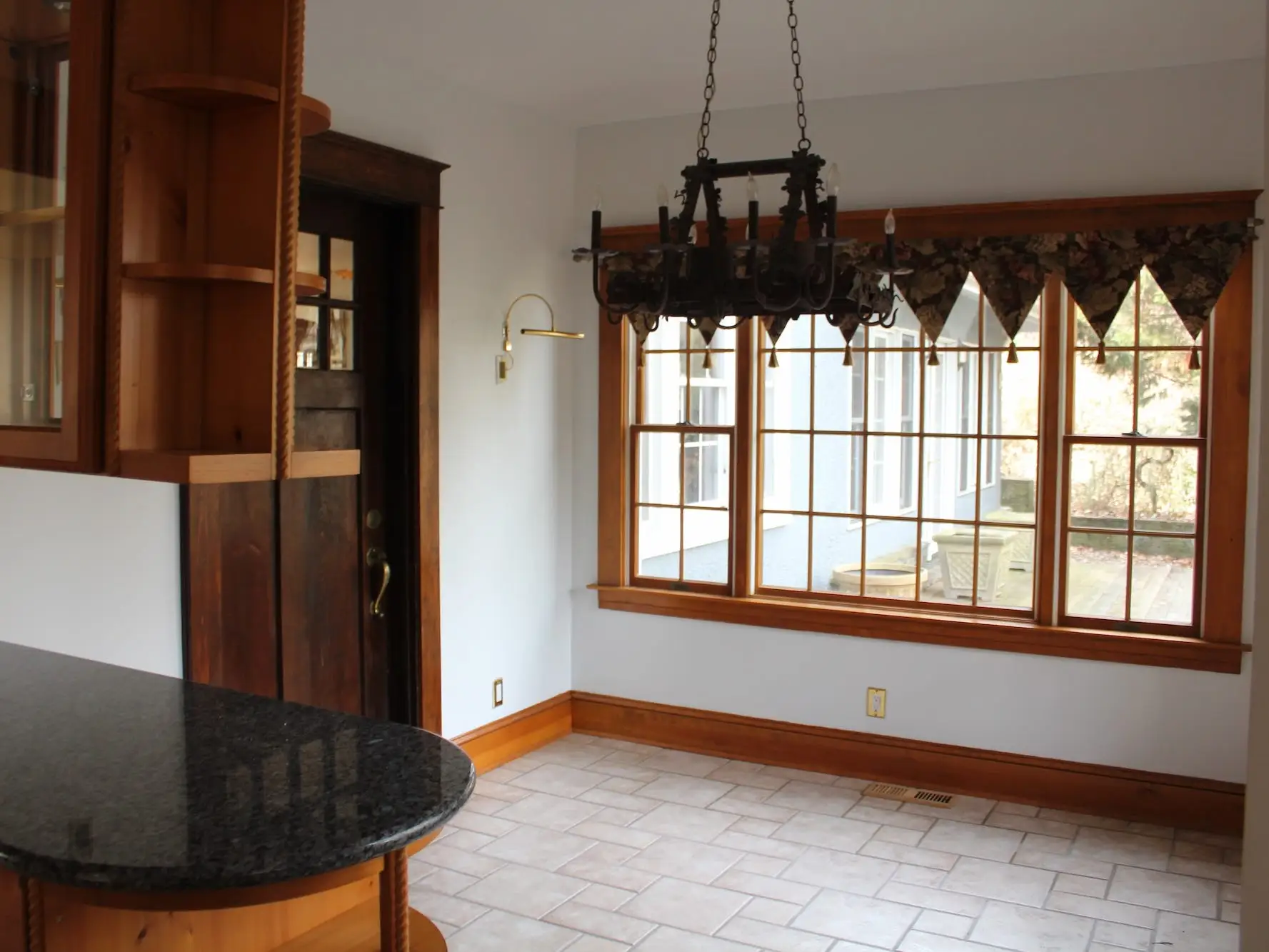 A kitchen with windows and a doorway.