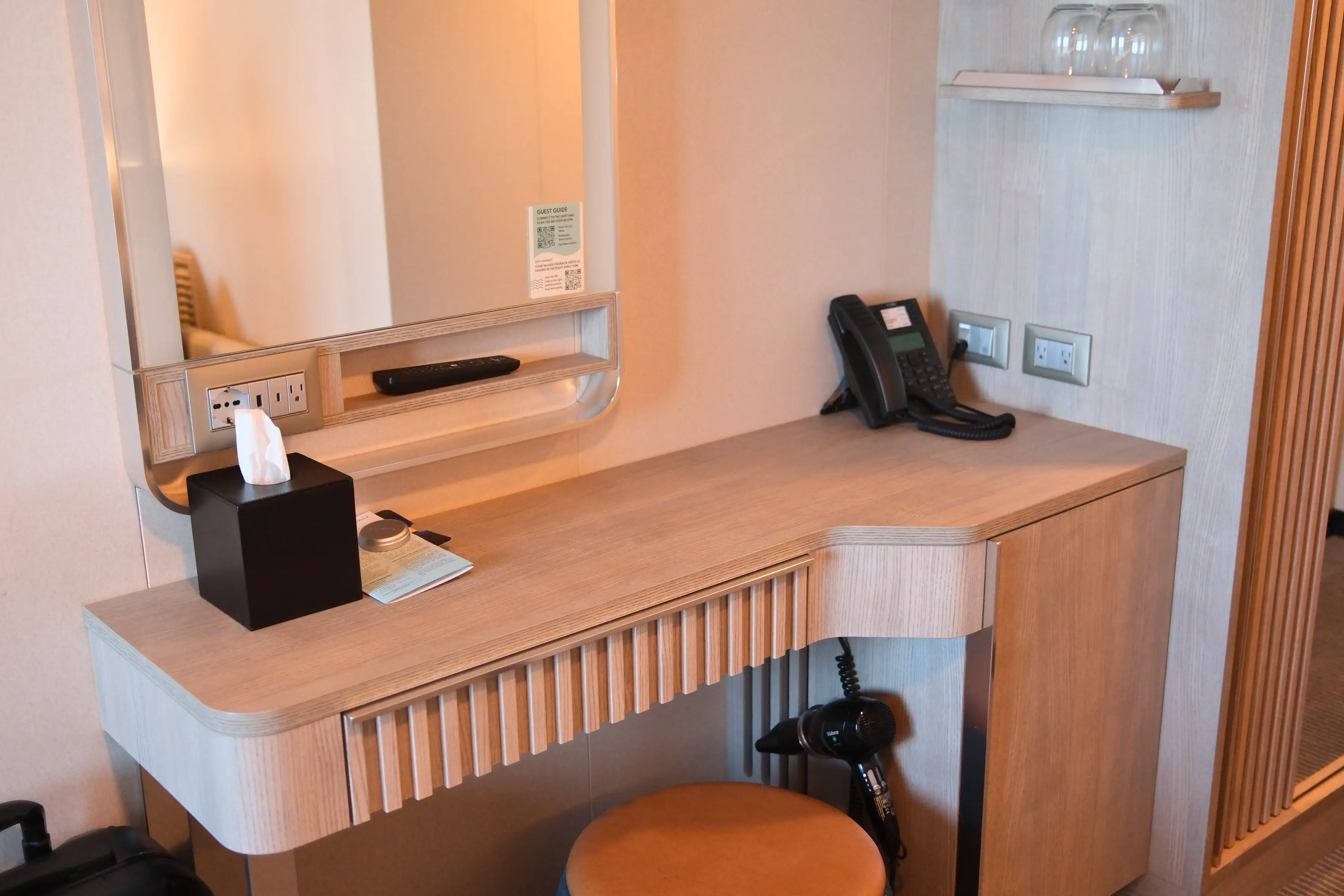 Desk/vanity area with tissue box, phone in room on Norwegian Luna
