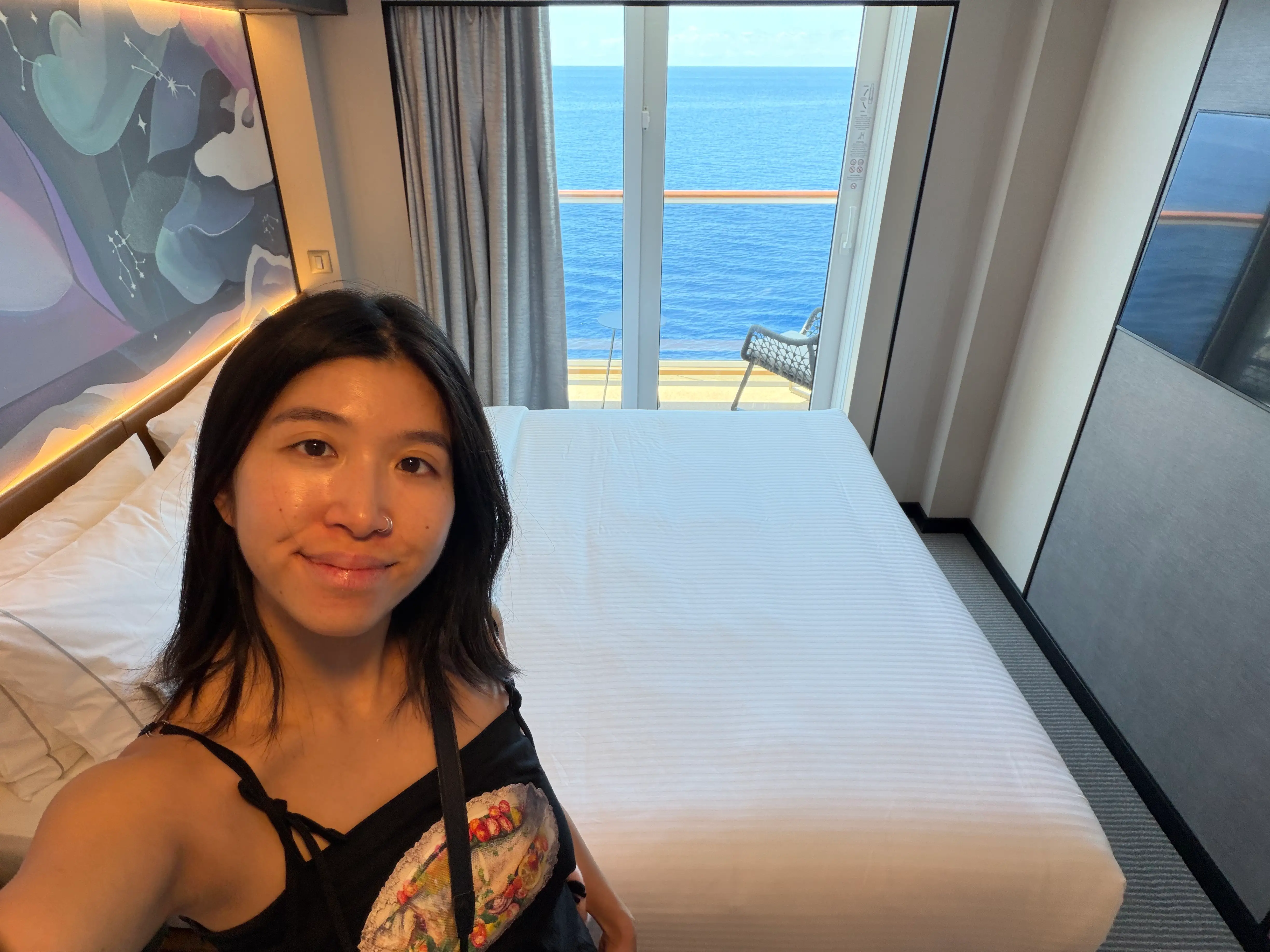 Author Brittany Chang smiling in room on Norwegian Luna