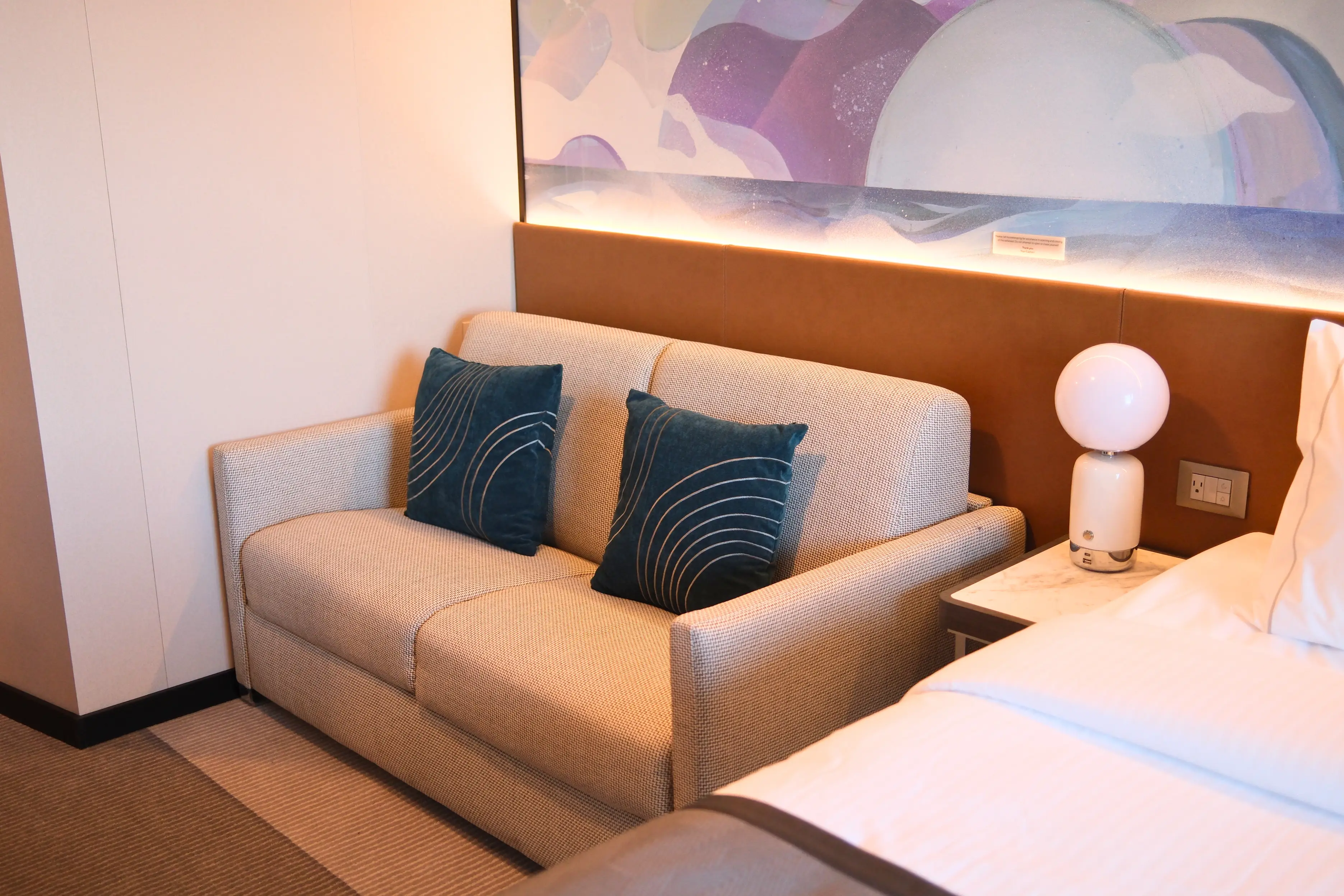 Couch with side table with lamp in room on Norwegian Luna