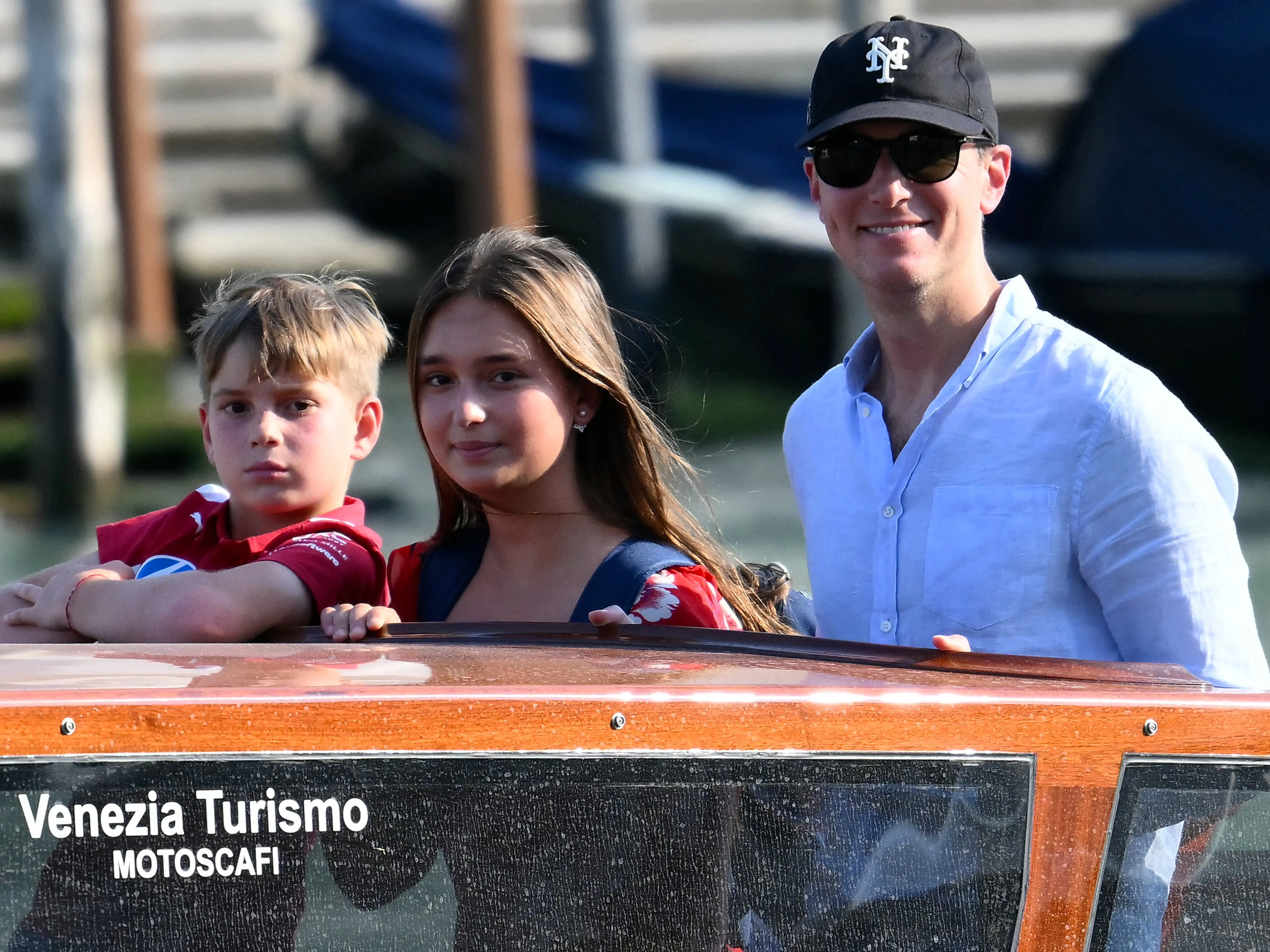 Jared Kushner (R) and two of his children Joseph (L) and Arabella (C) stand on a taxi boat as they arrive at the St Regis Hotel ahead of the wedding of Amazon founder Jeff Bezos in Venice on June 24, 2025