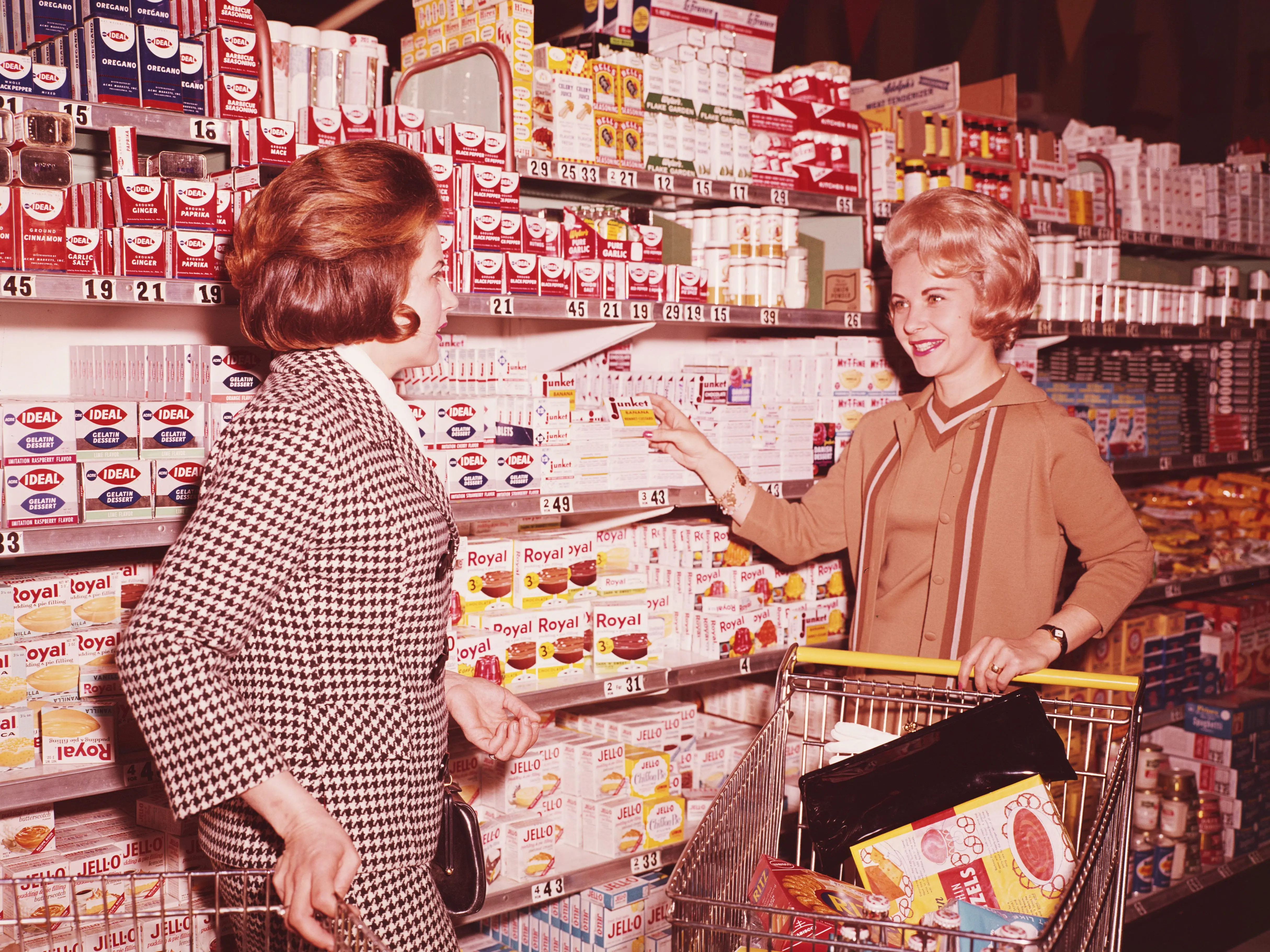 Two women shop in a grocery store.