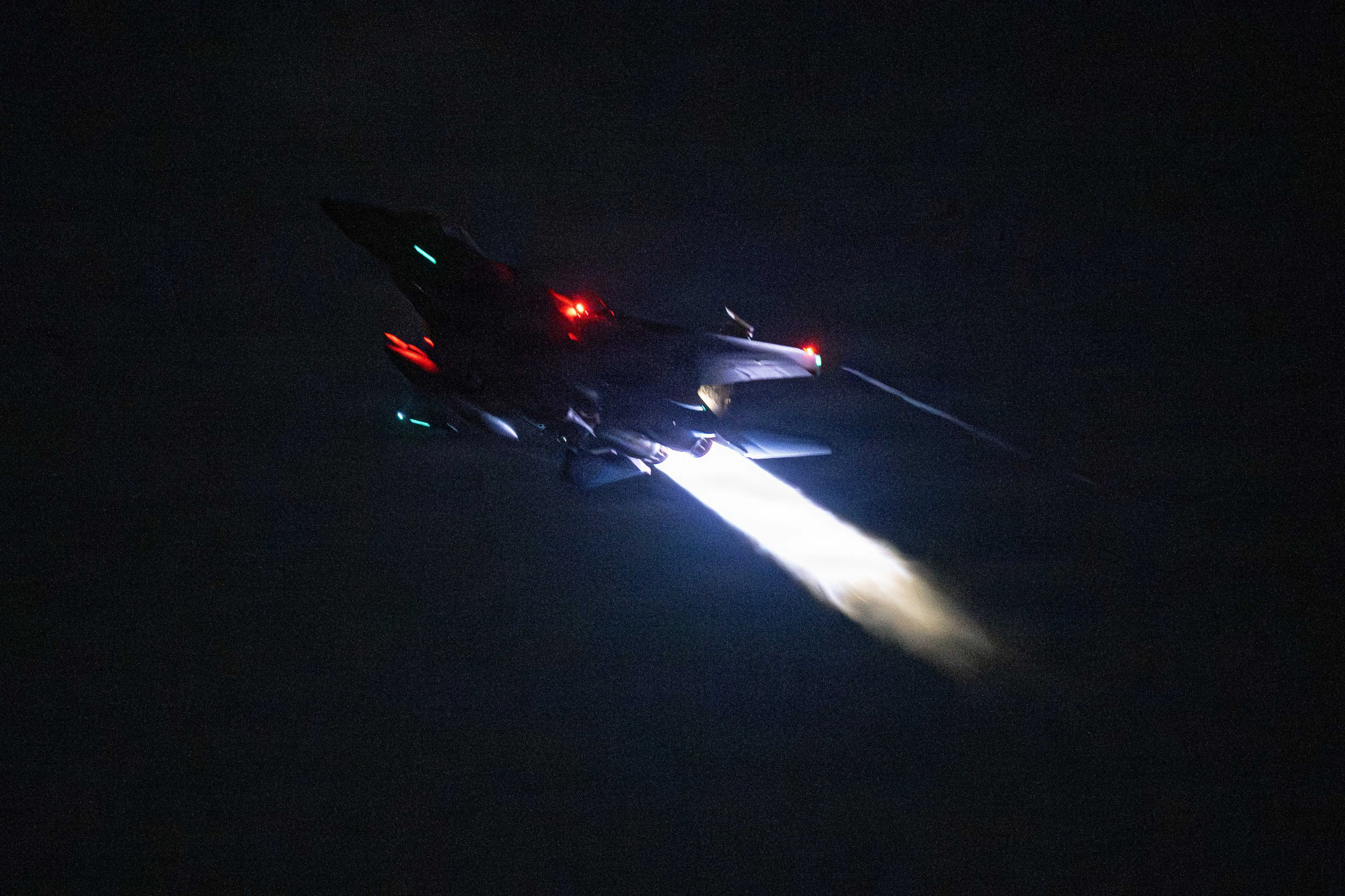 A US Air Force F-15 fighter flies in the night.