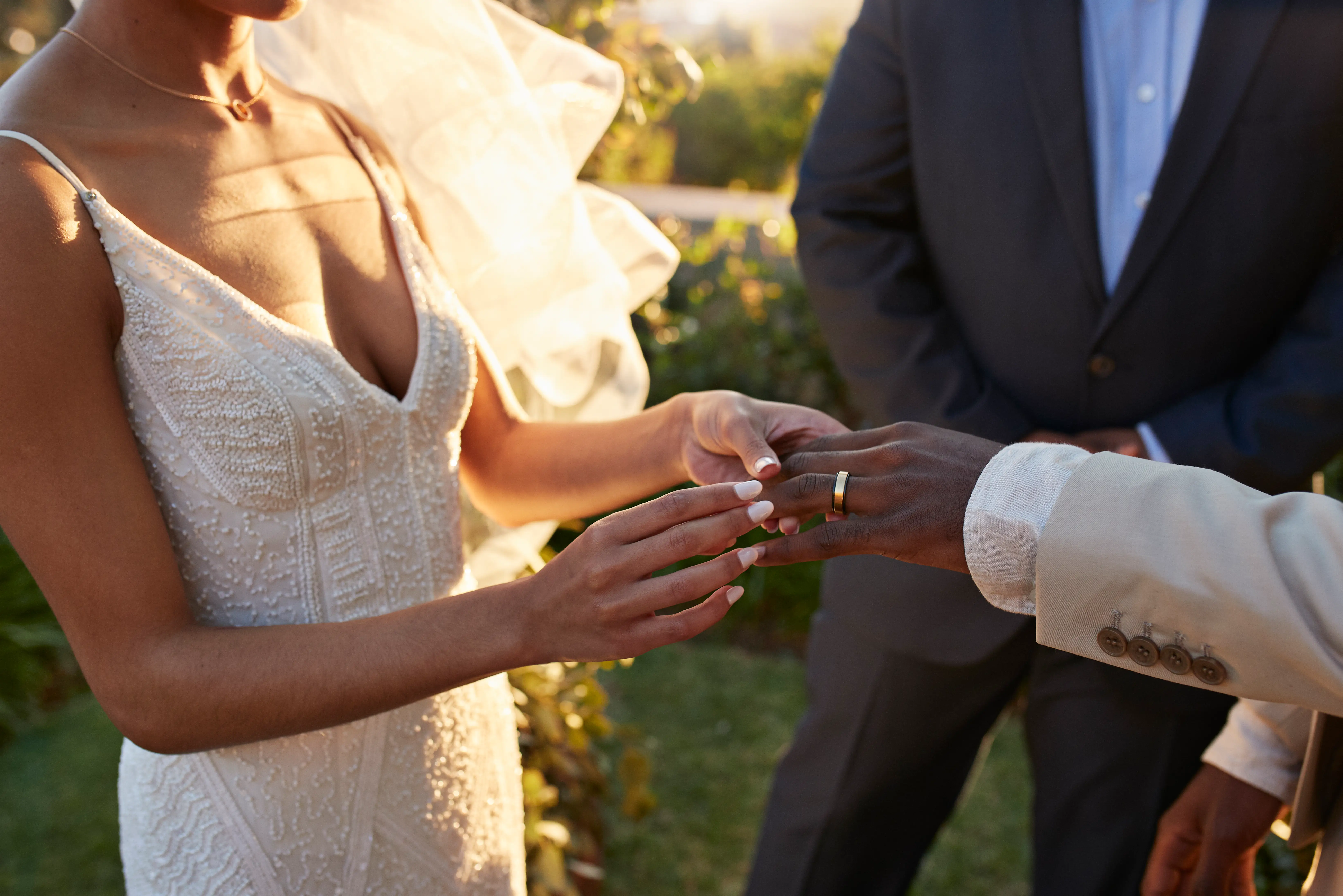 Bride and groom exchanging wedding rings