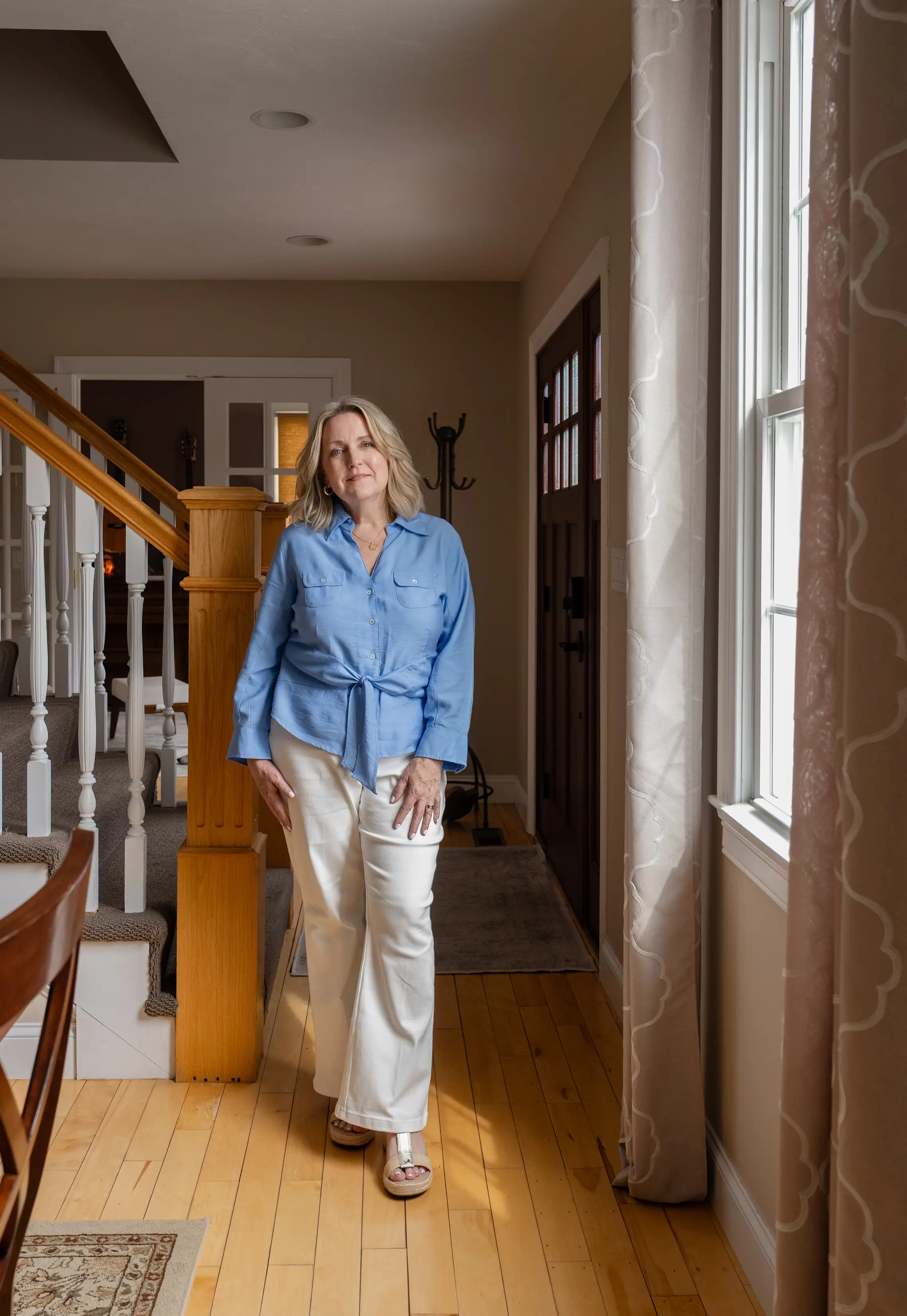 Juli Ford standing in front of her staircase