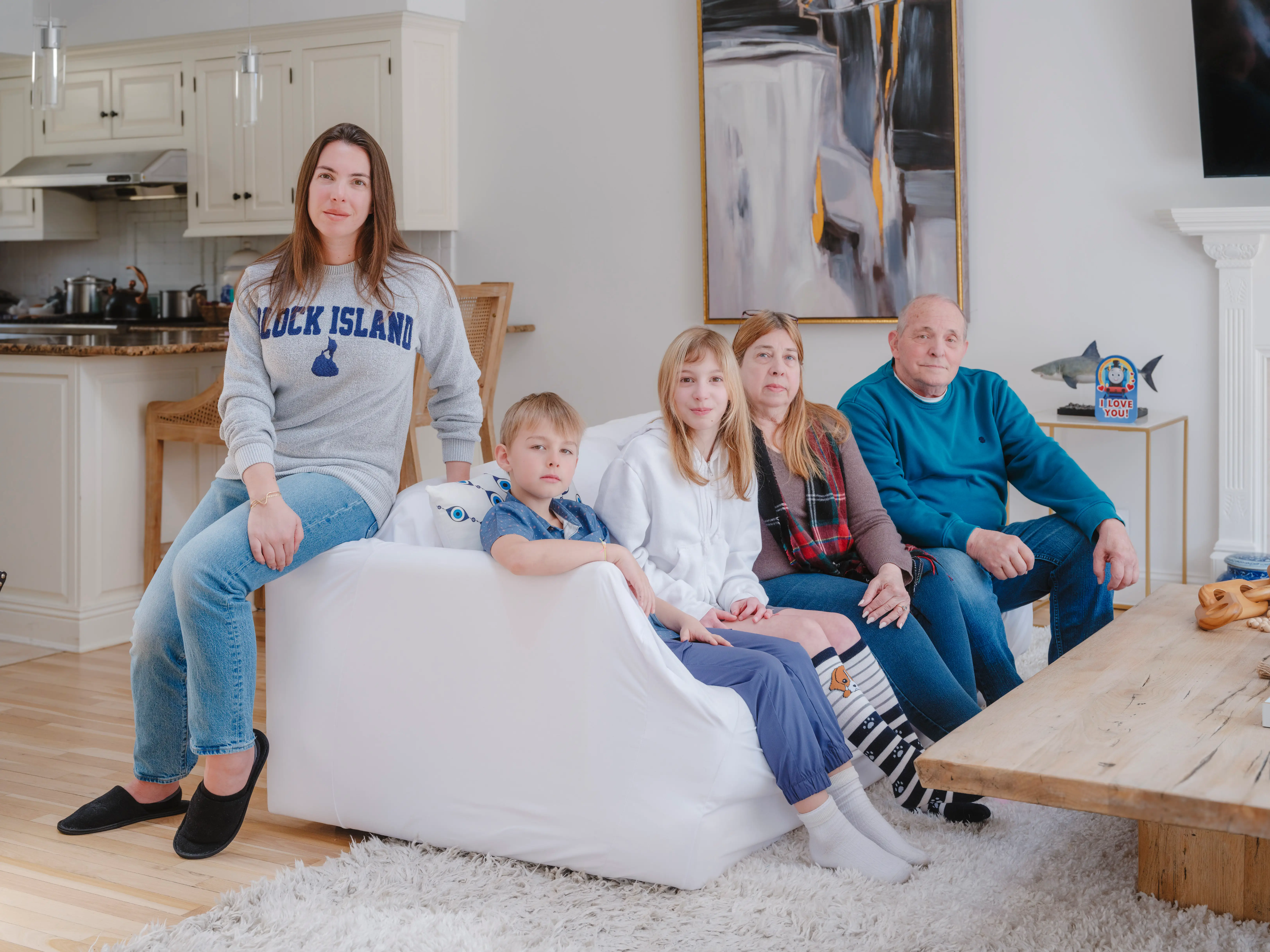 Vanessa Gordon and family sitting a couch in the living room