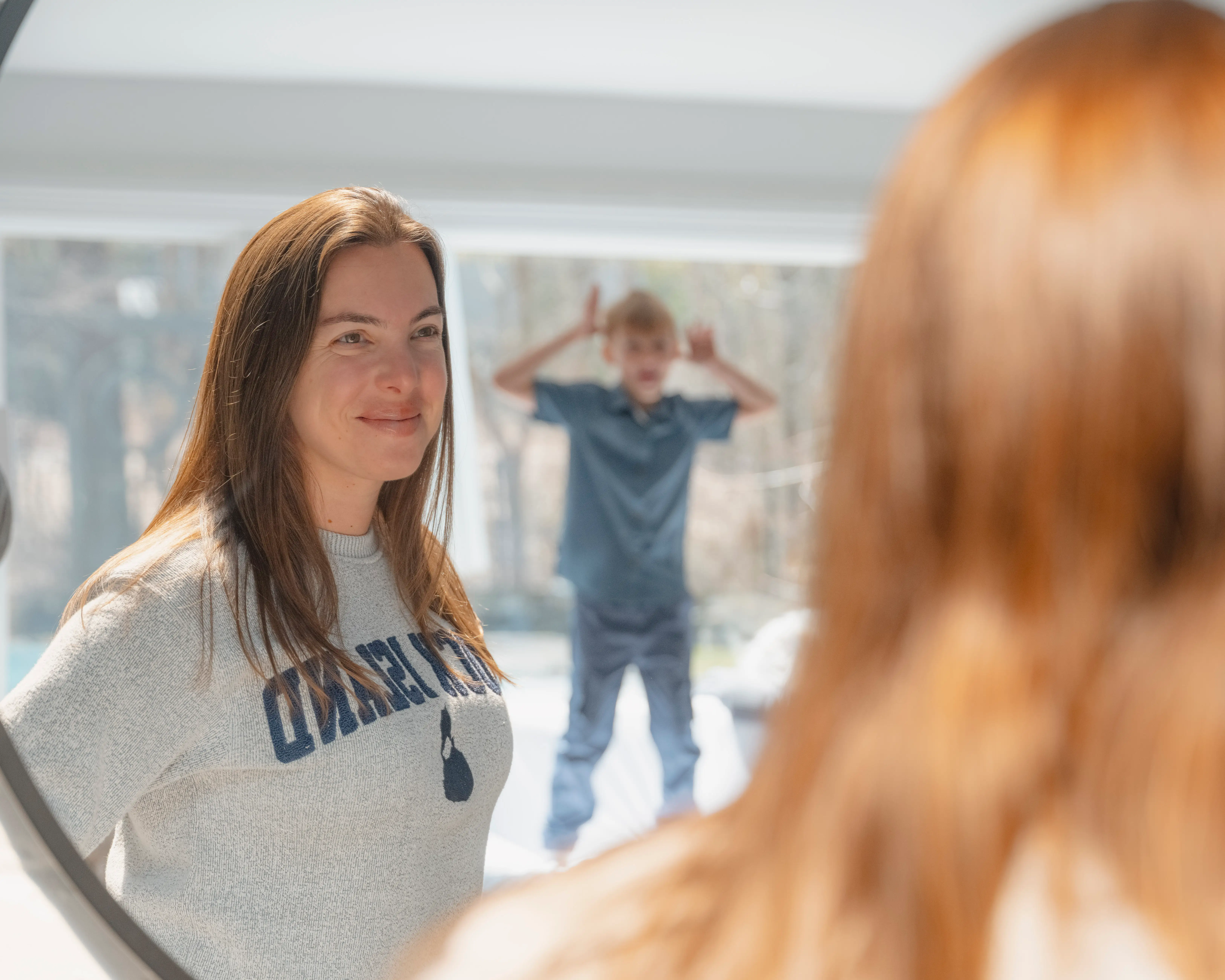 Vanessa Gordon looking at her son in the mirror
