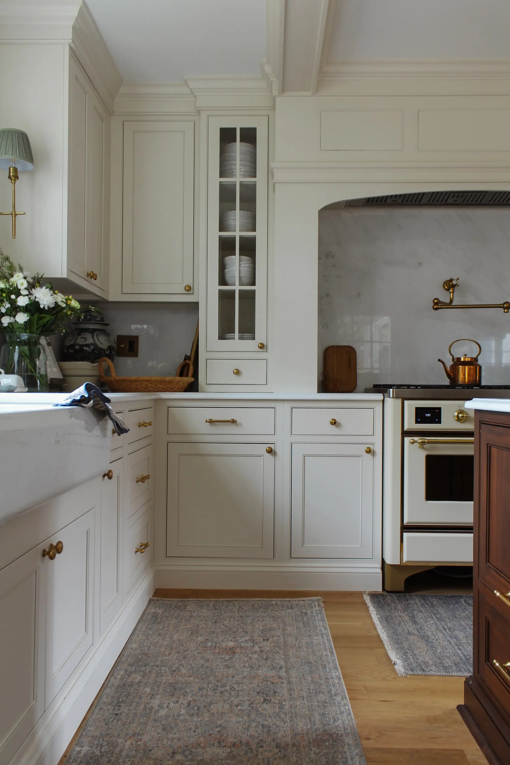 A kitchen with white cabinetry and a large sink.