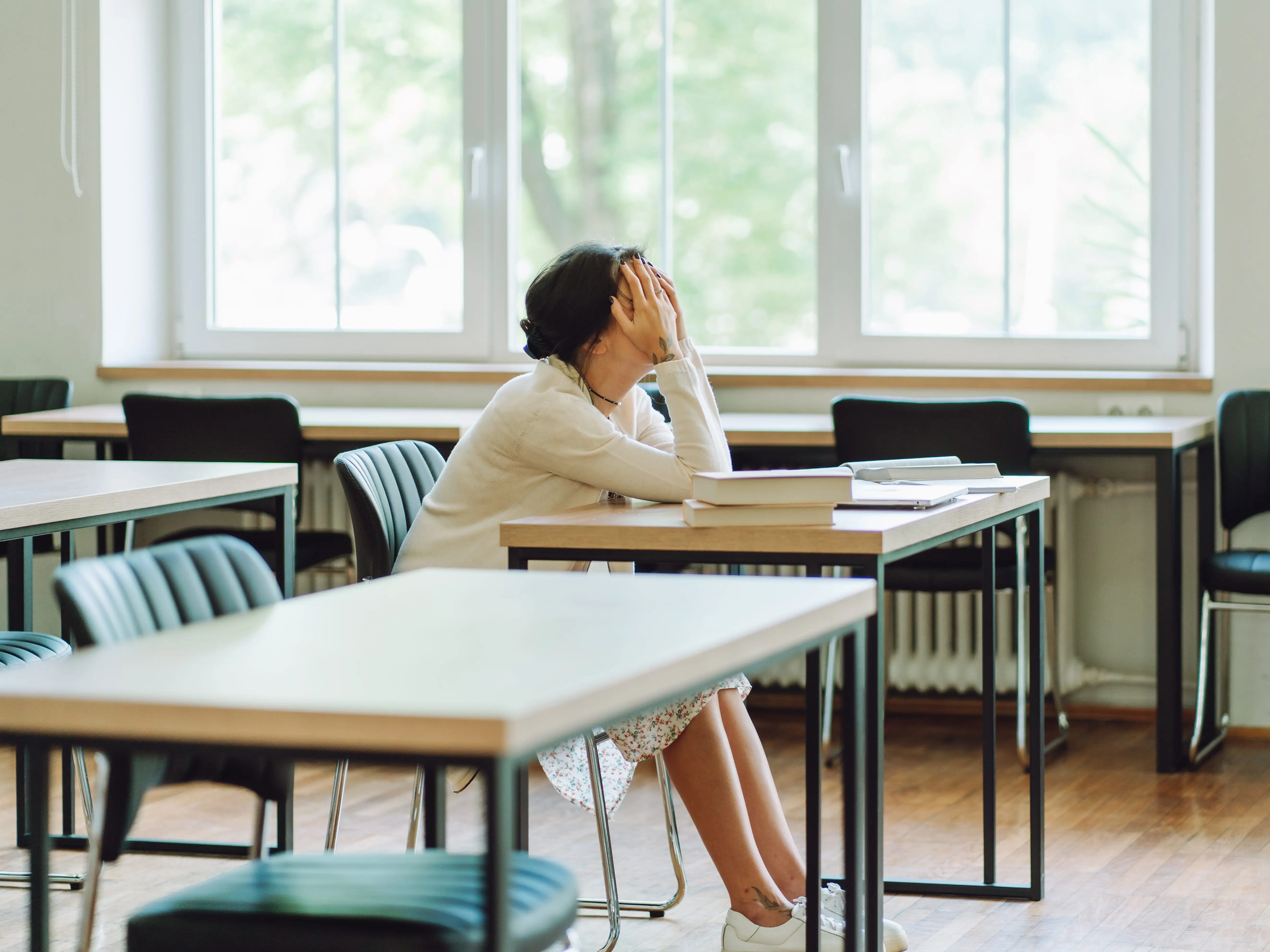 Woman with head in hands