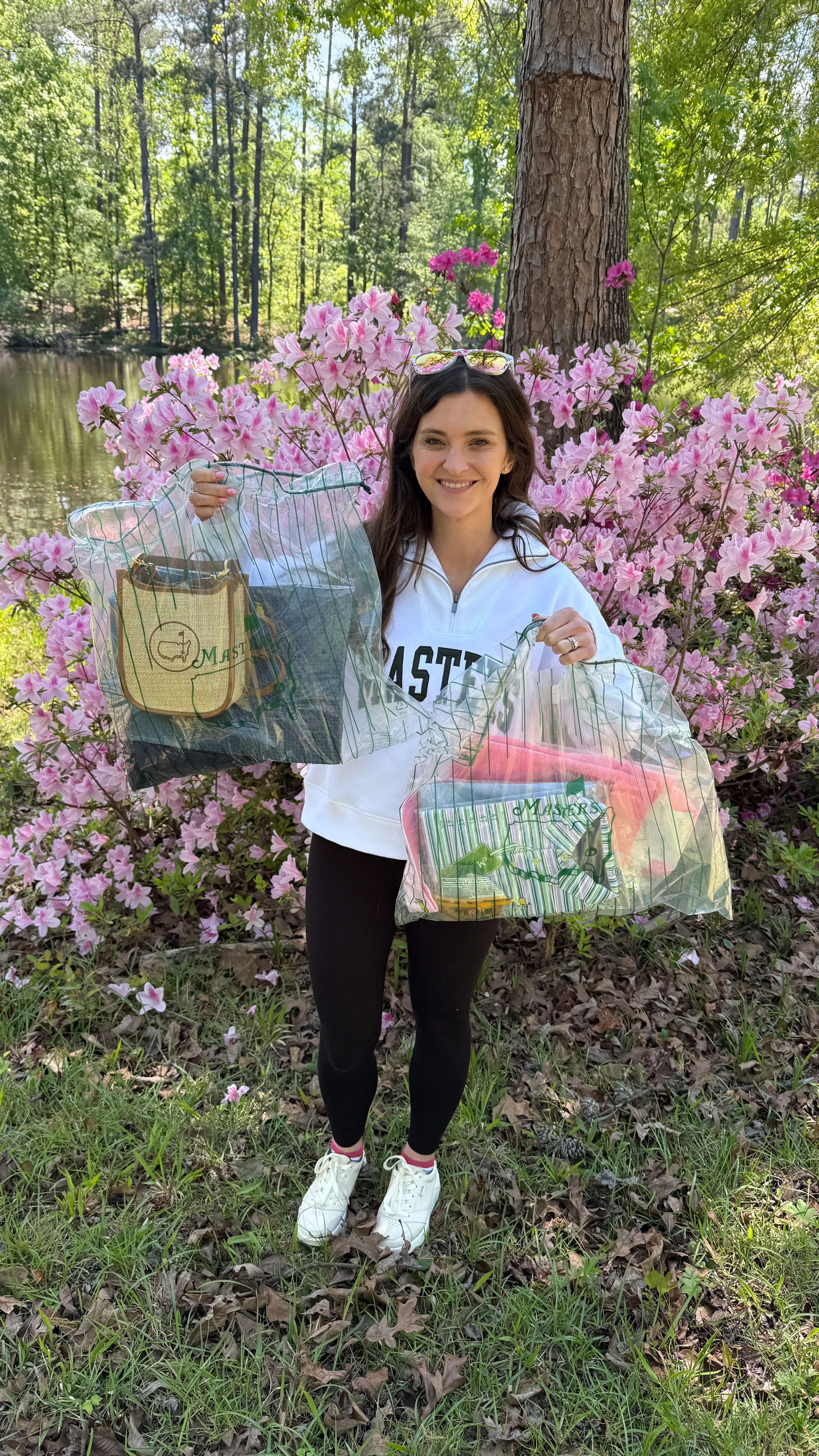 Savanna Perry holds and wears her merchandise from the Masters Tournament.