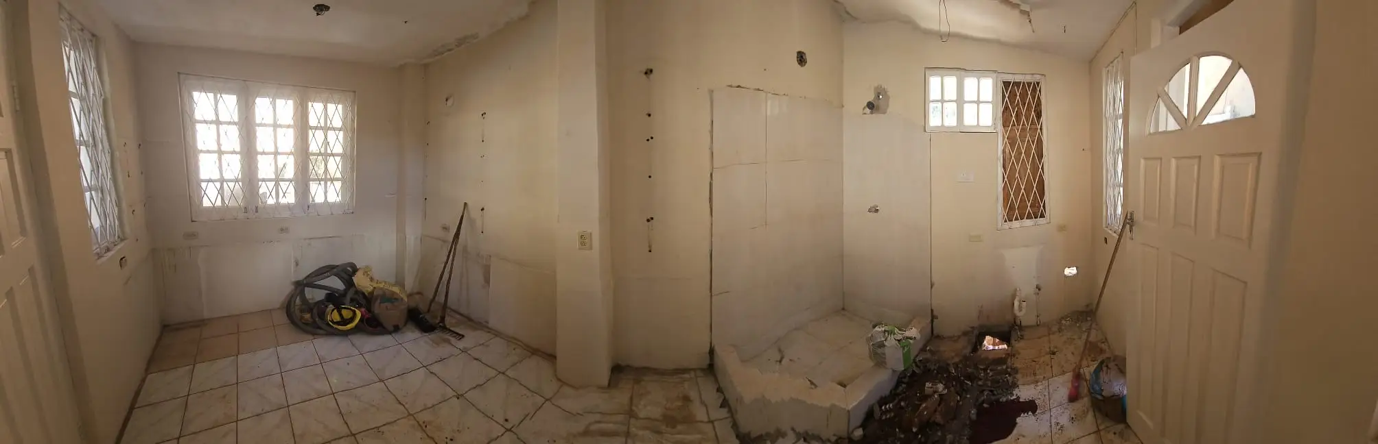 A panoramic view of an unused pool house.