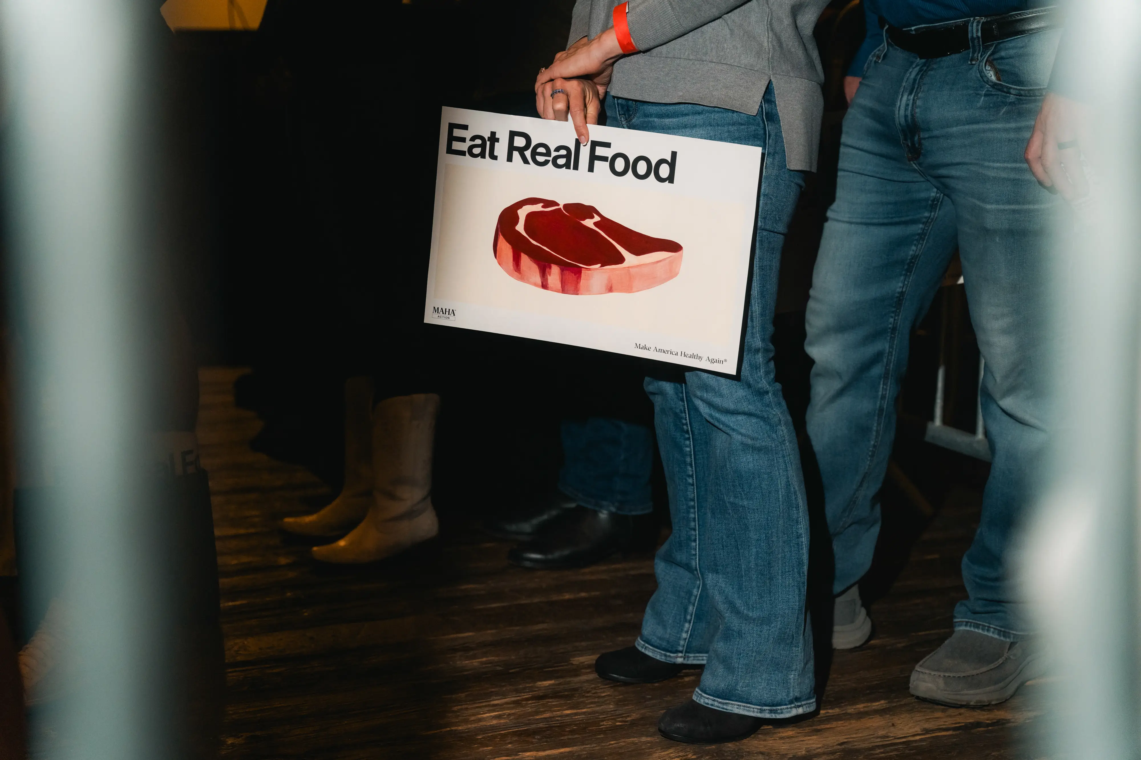 A sign with a steak on it and the text
