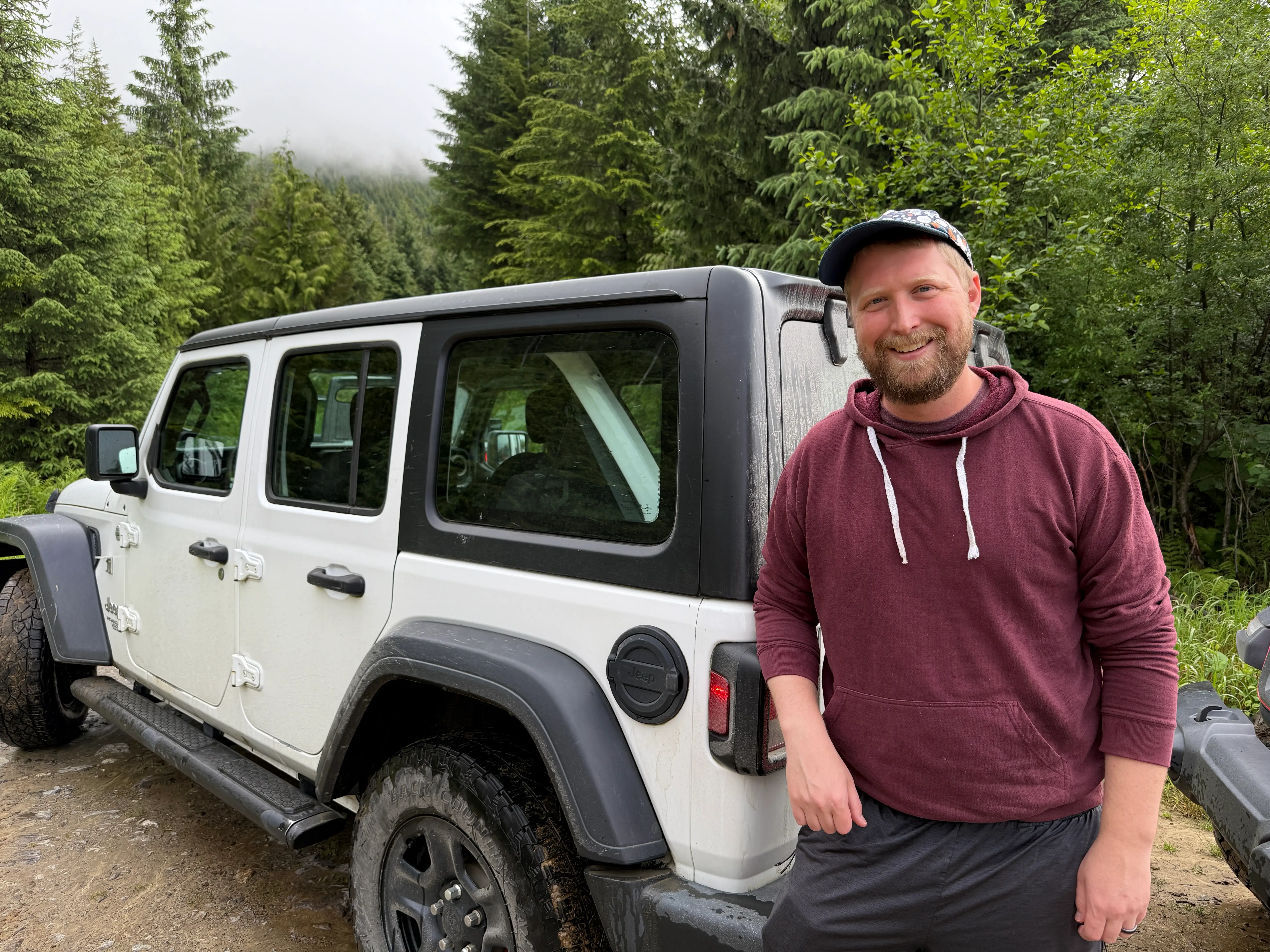 Man smiling next to Jeep