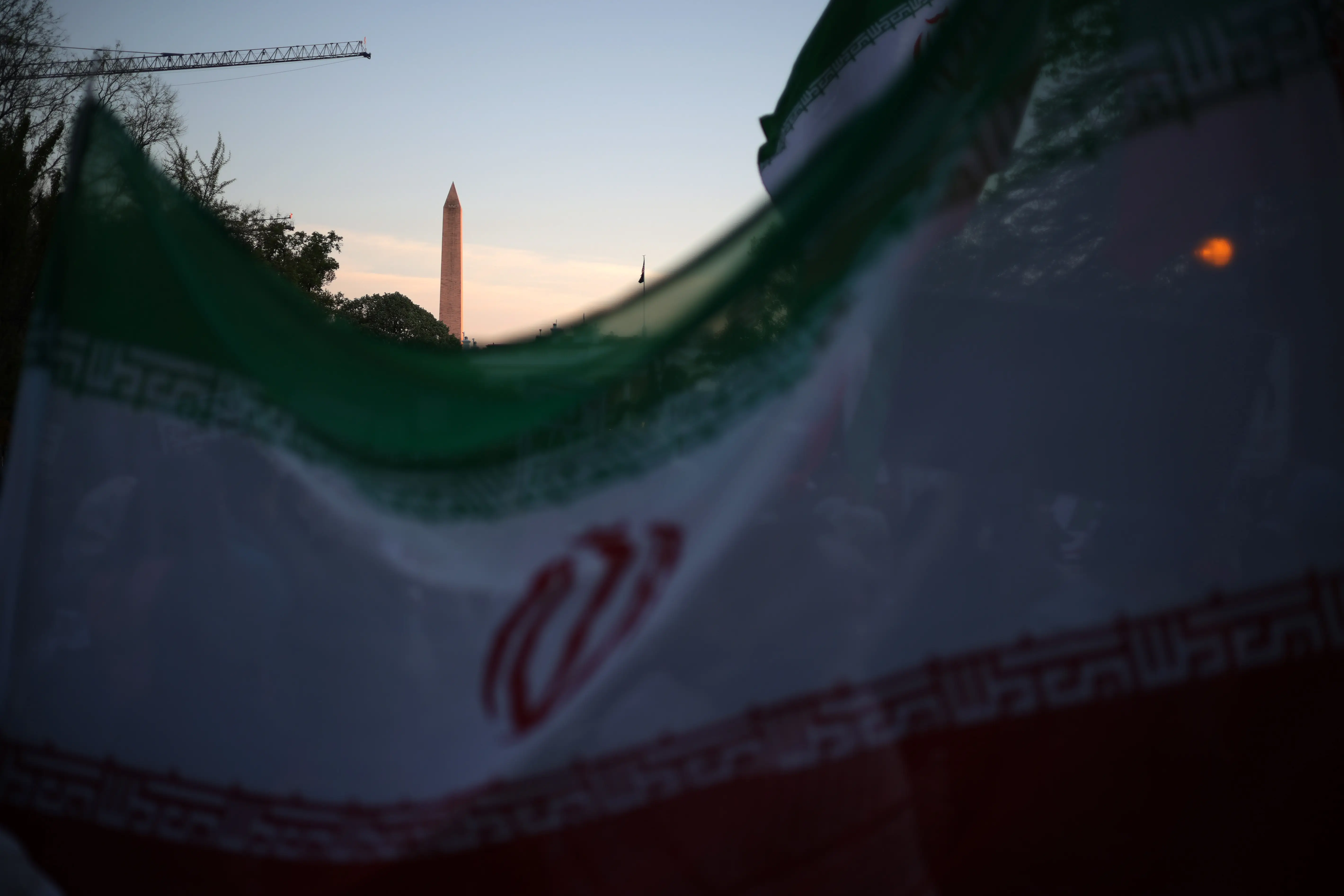 An Iran flag waves in front of the Washington monument.