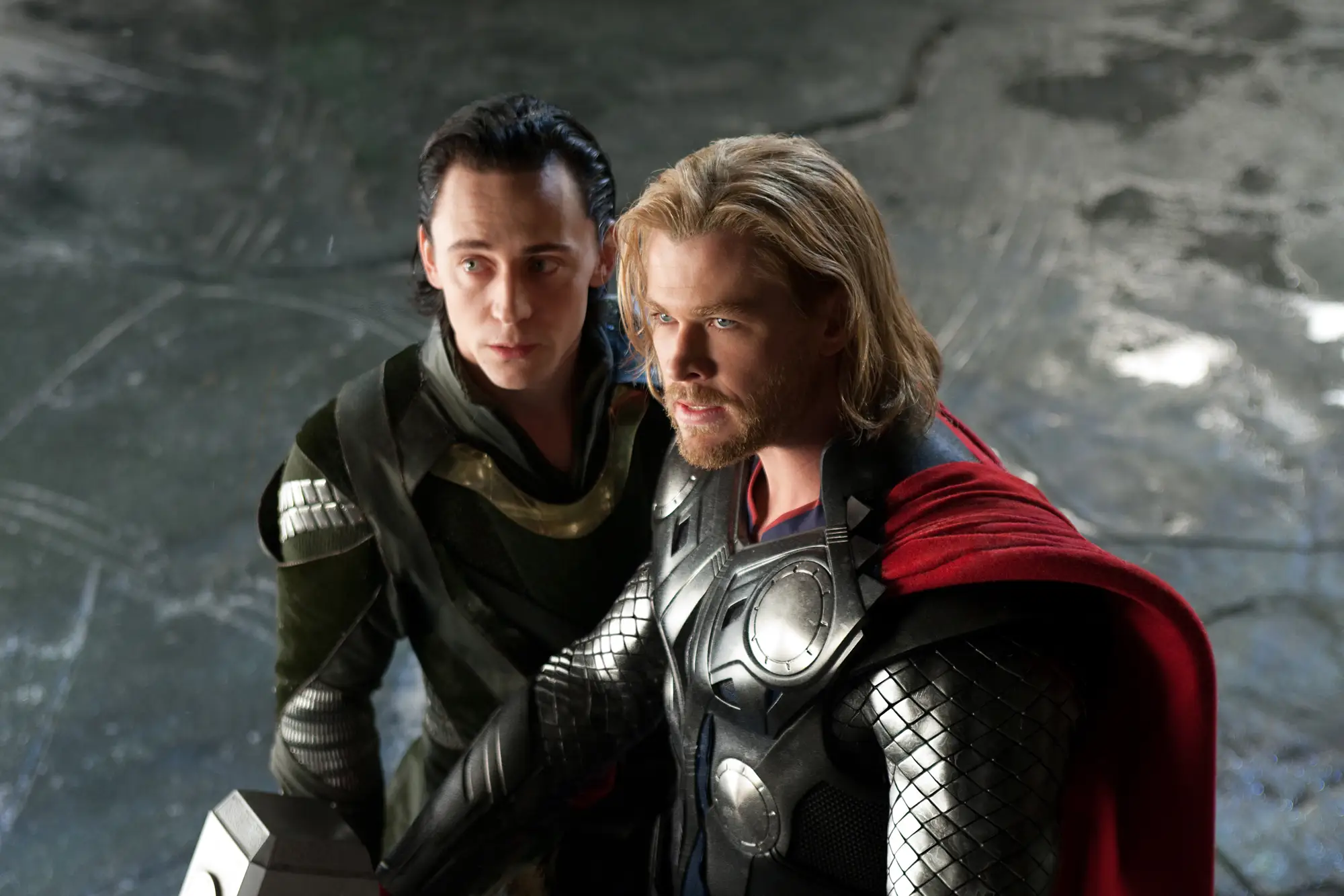 Tom Hiddleston as Loki standing next to Chris Hemsworth as Thor in Thor movie
