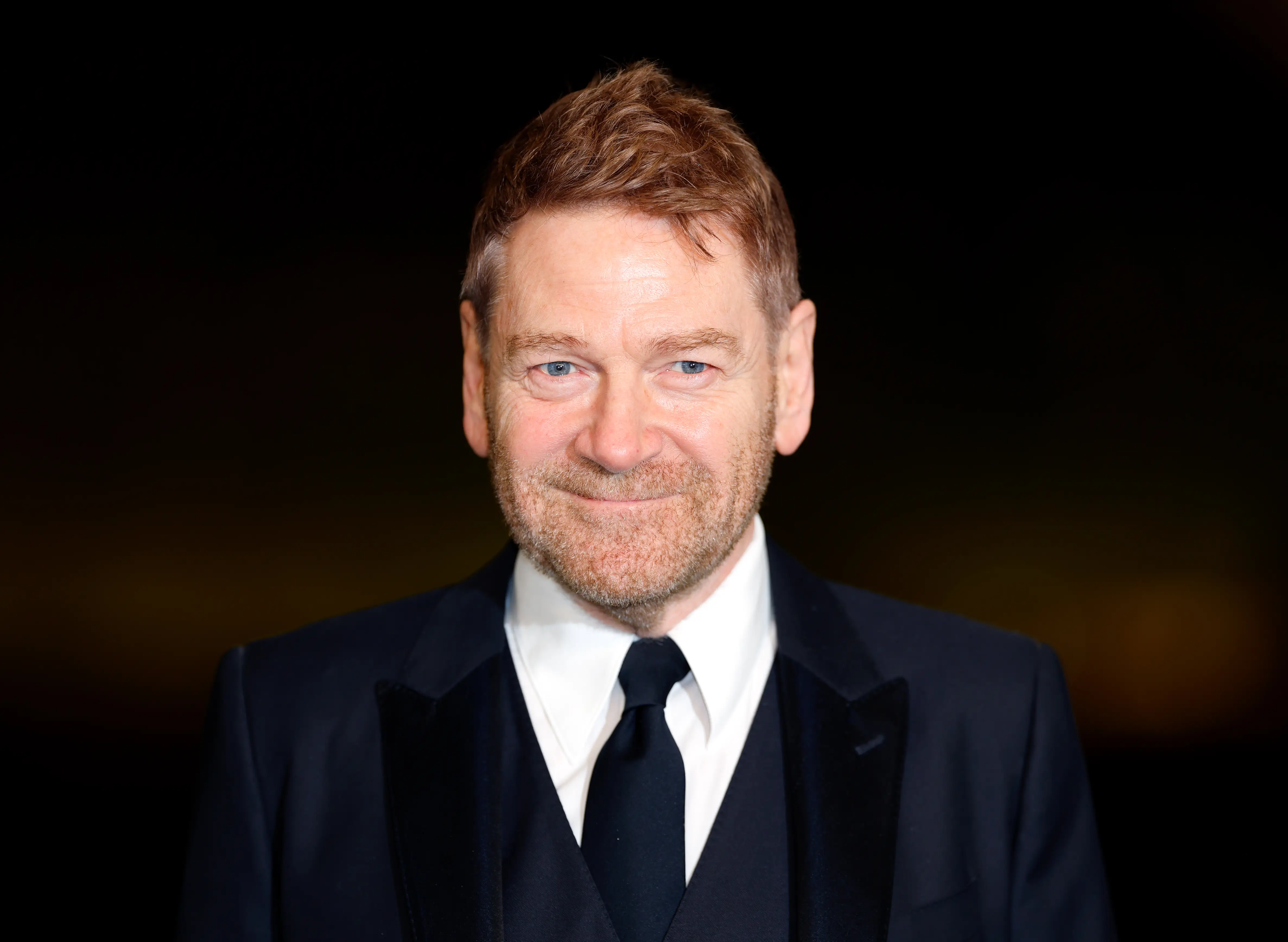 Kenneth Branagh in a suit and tie