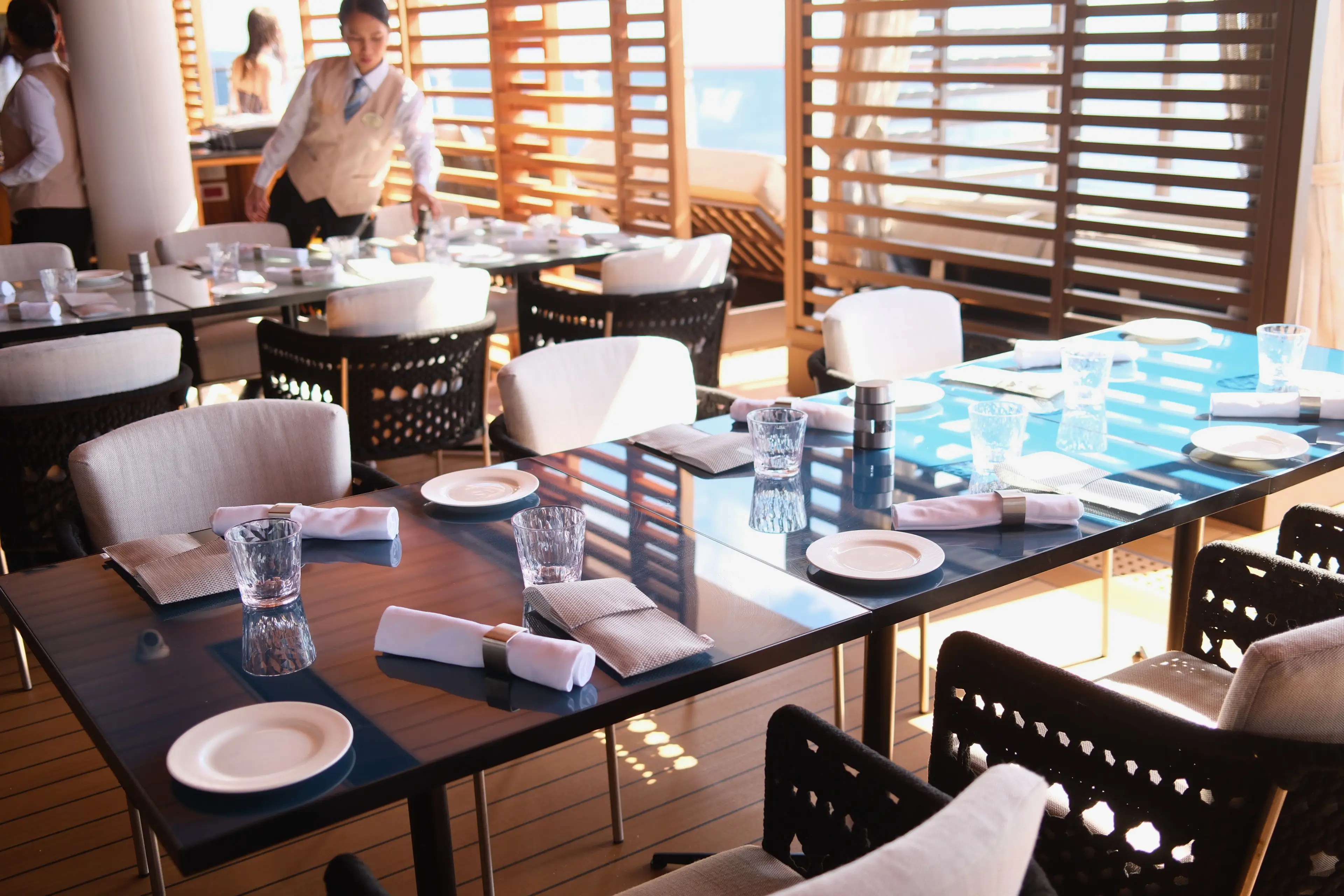 Table with napkins, small plates next to slatted wal