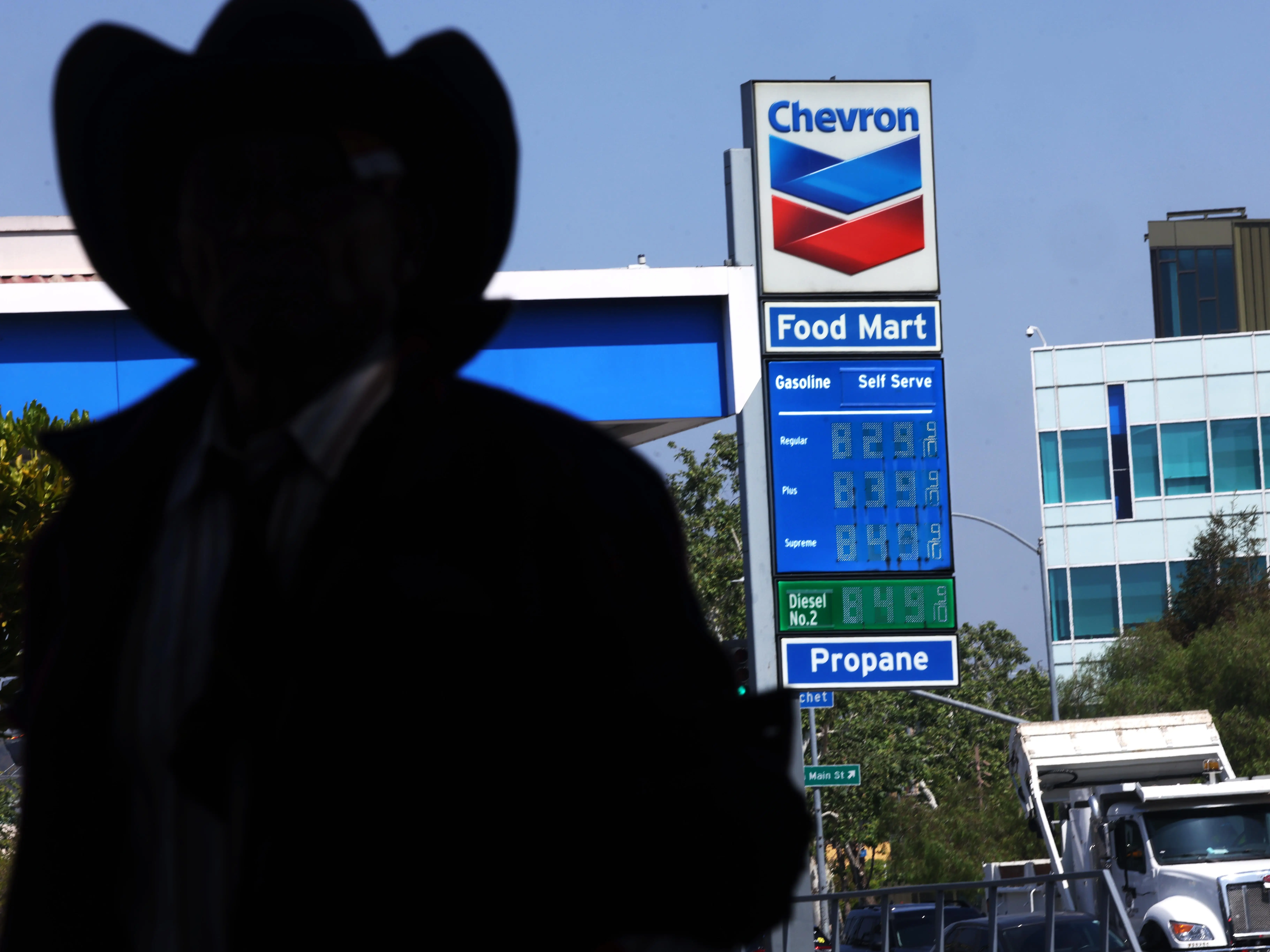 A person near a Chevron gas station