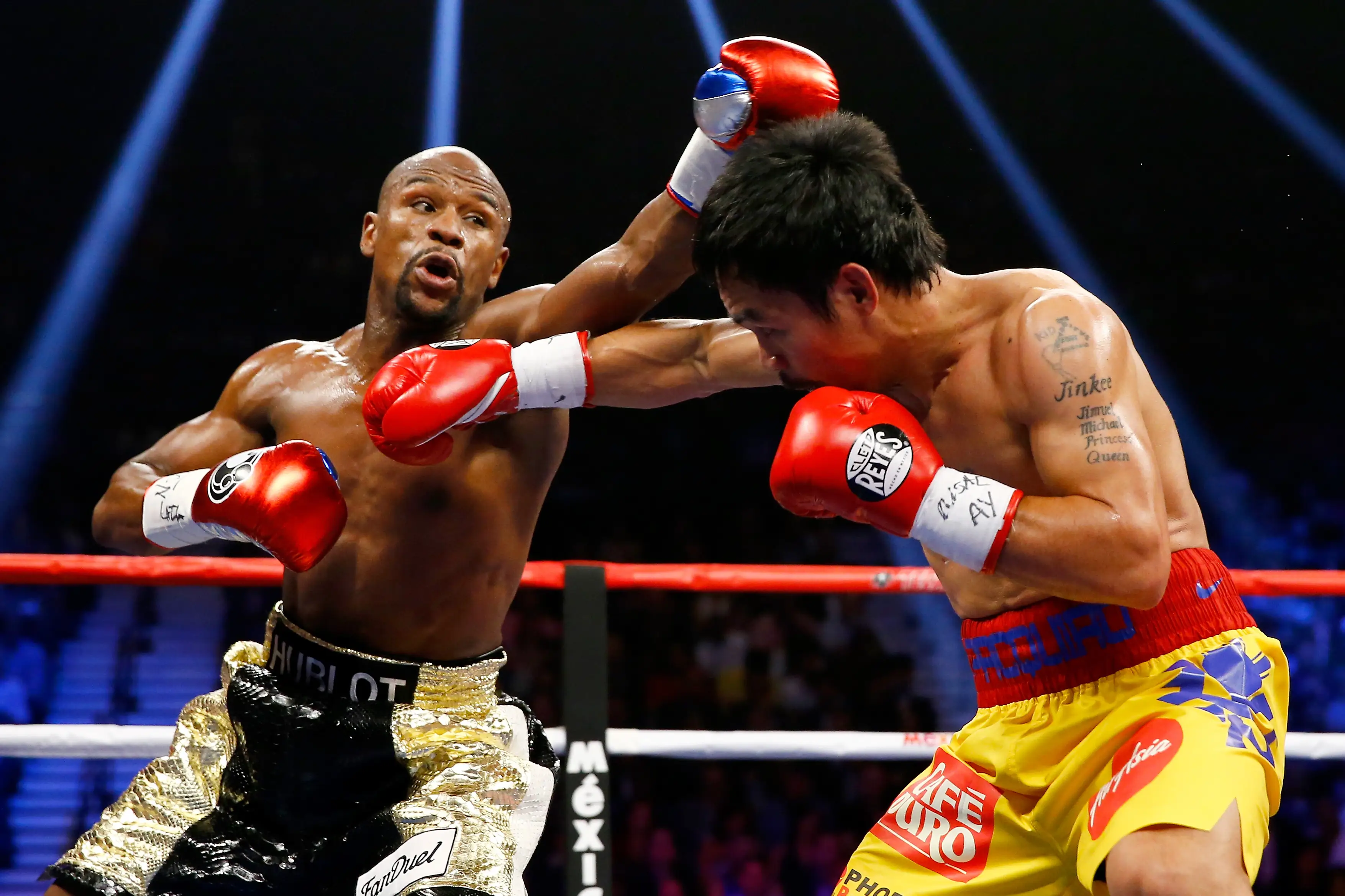 Floyd Mayweather punches Manny Pacquiao during a 2015