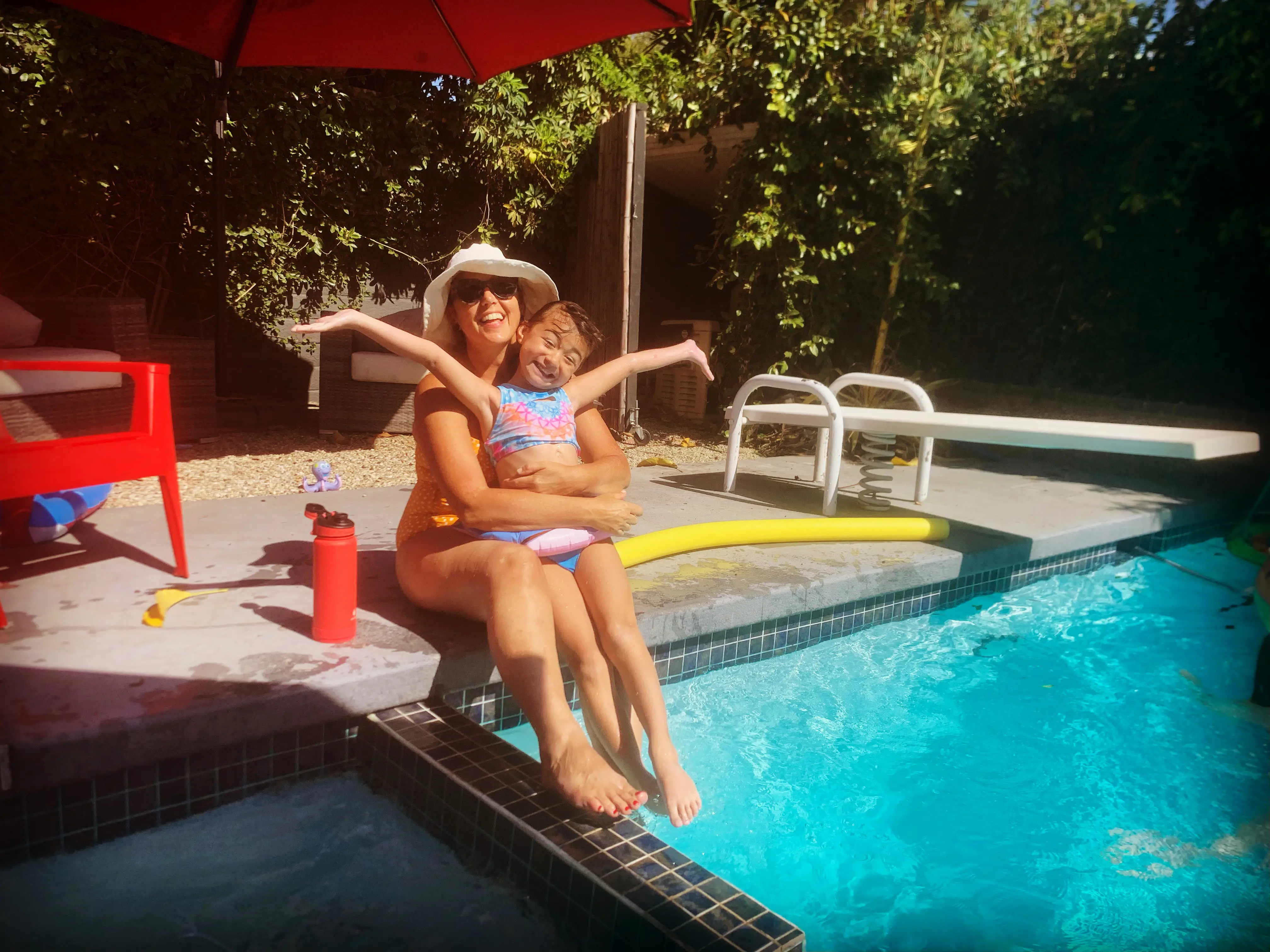 Woman and girl by pool