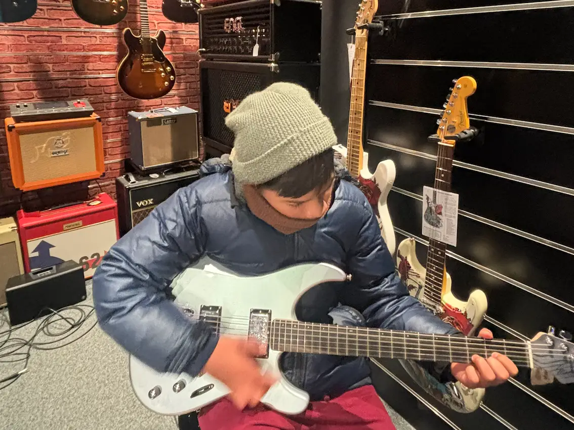 Tween playing guitar