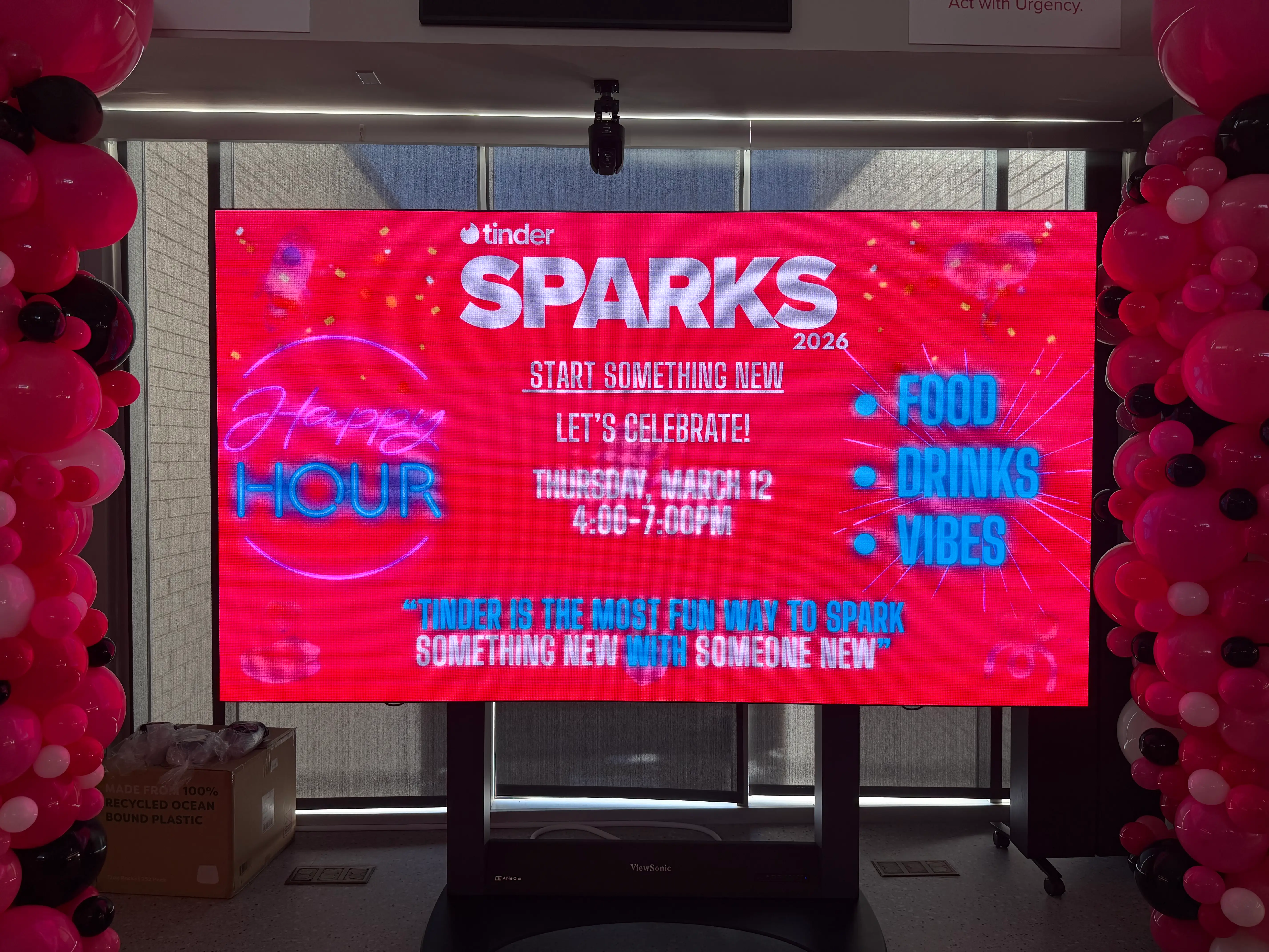 A TV advertising the Tinder Sparks happy hour is pictured.