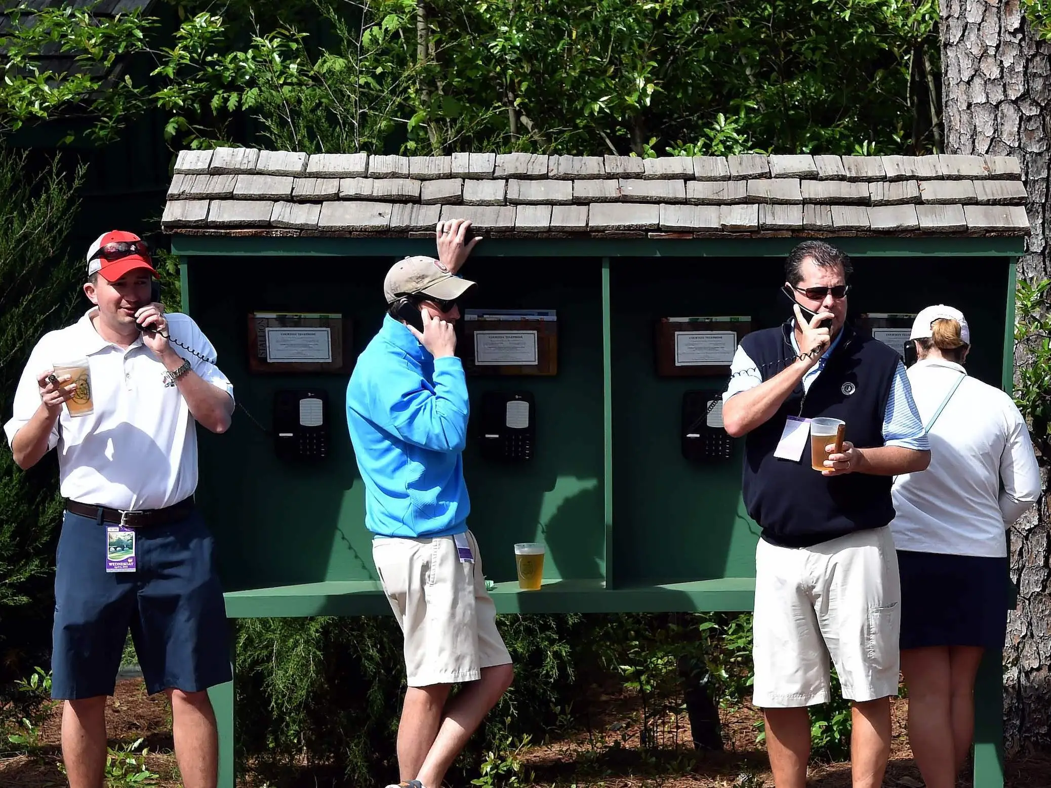 Masters patrons using pay phones.