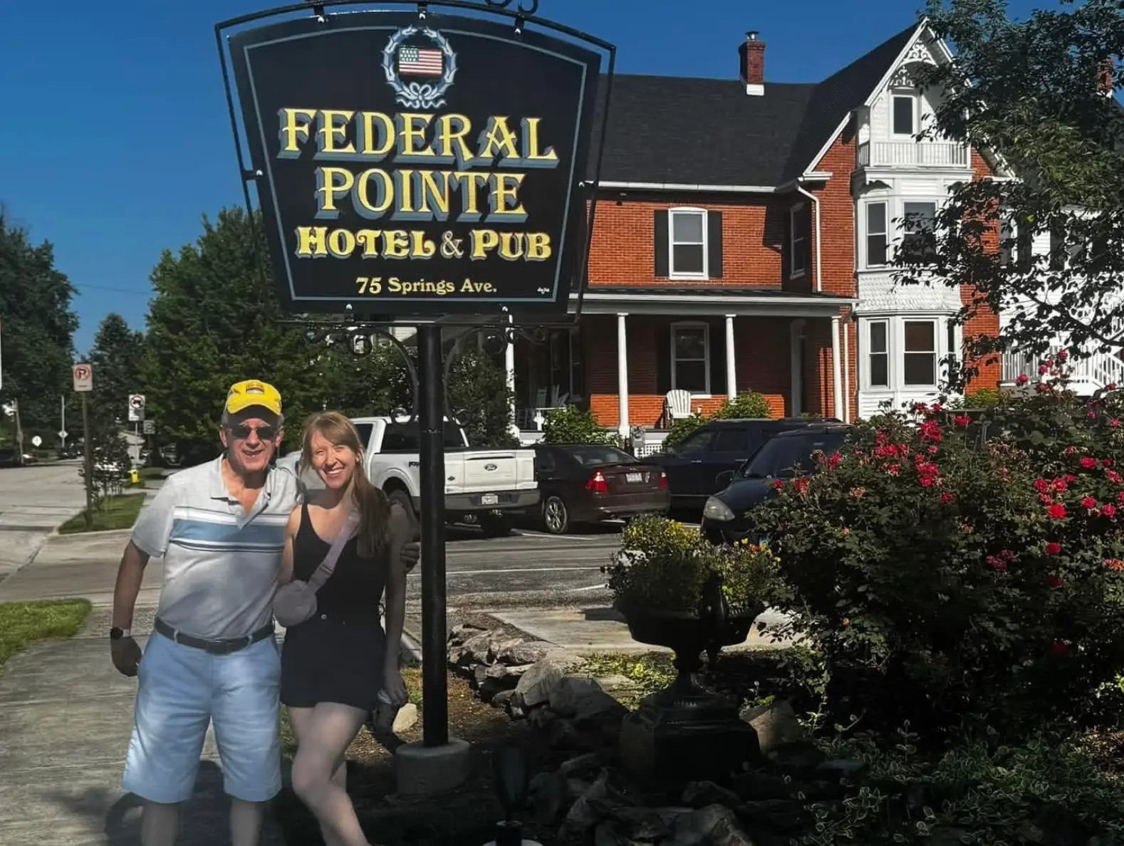 The writer and her dad standing in front of Federal Pointe Hotel & Pub in the springtime.