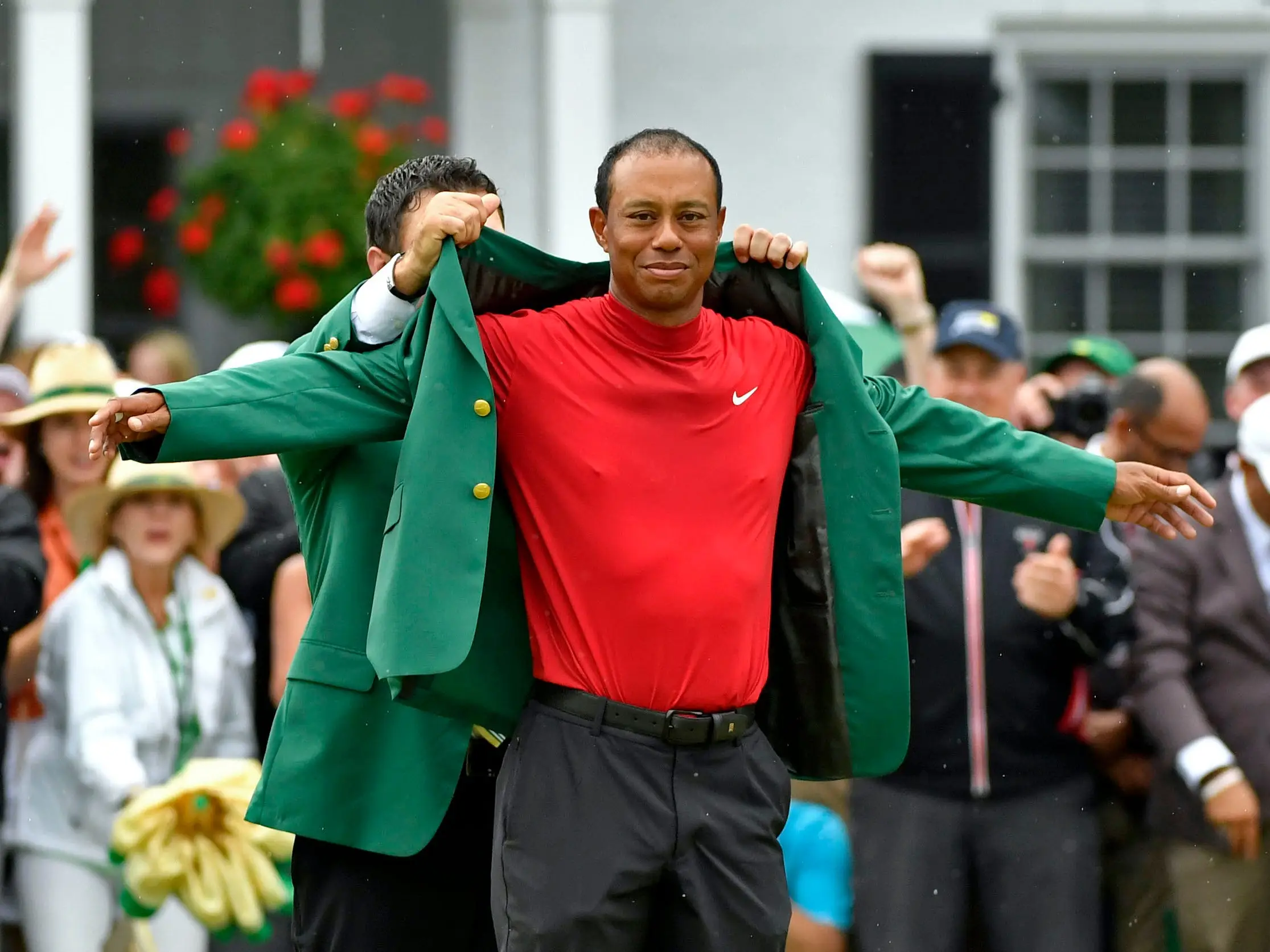 Tiger Woods is presented with the green jacket after winning the 2019 Masters at Augusta National.