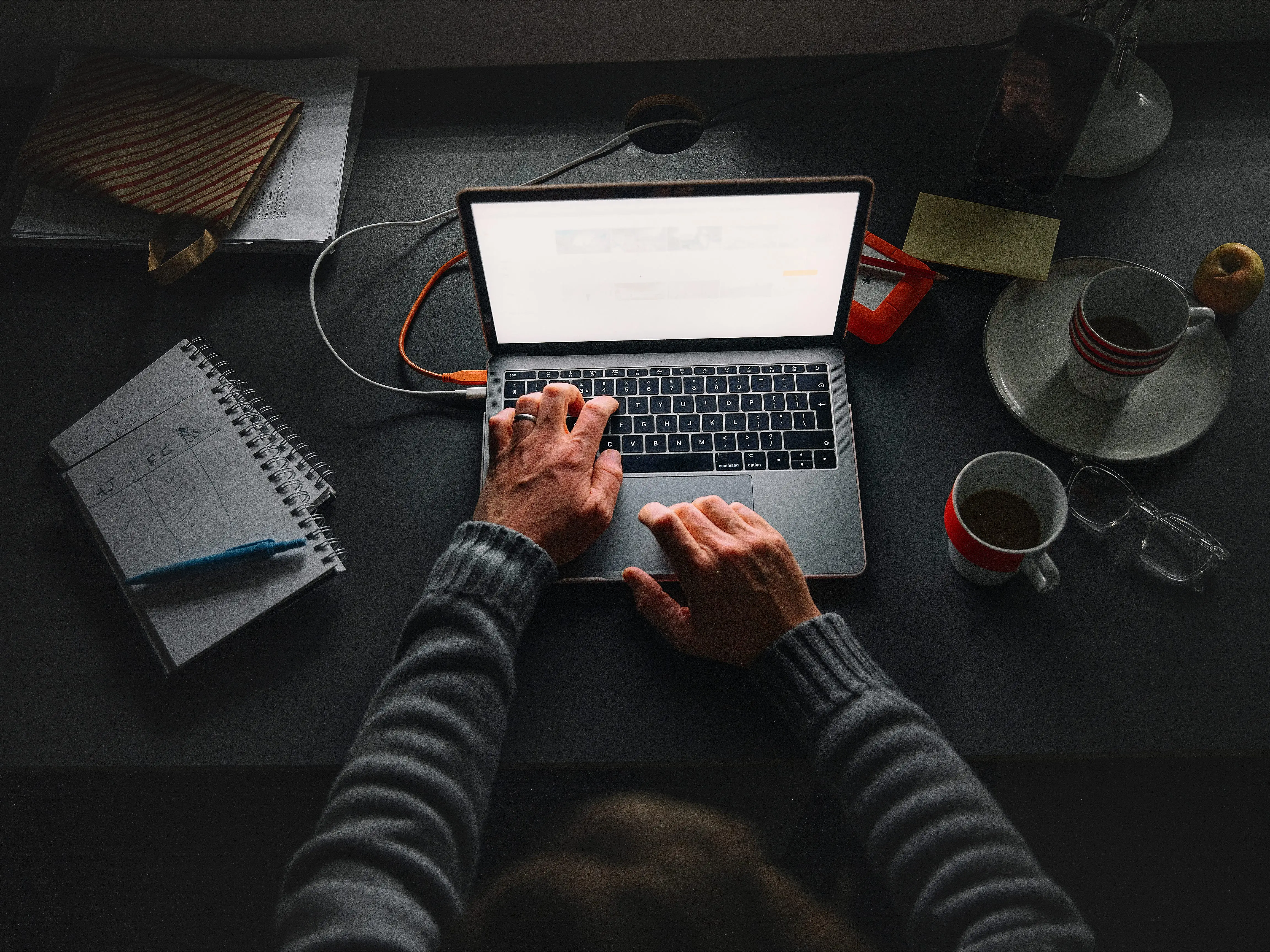 A person types on a laptop