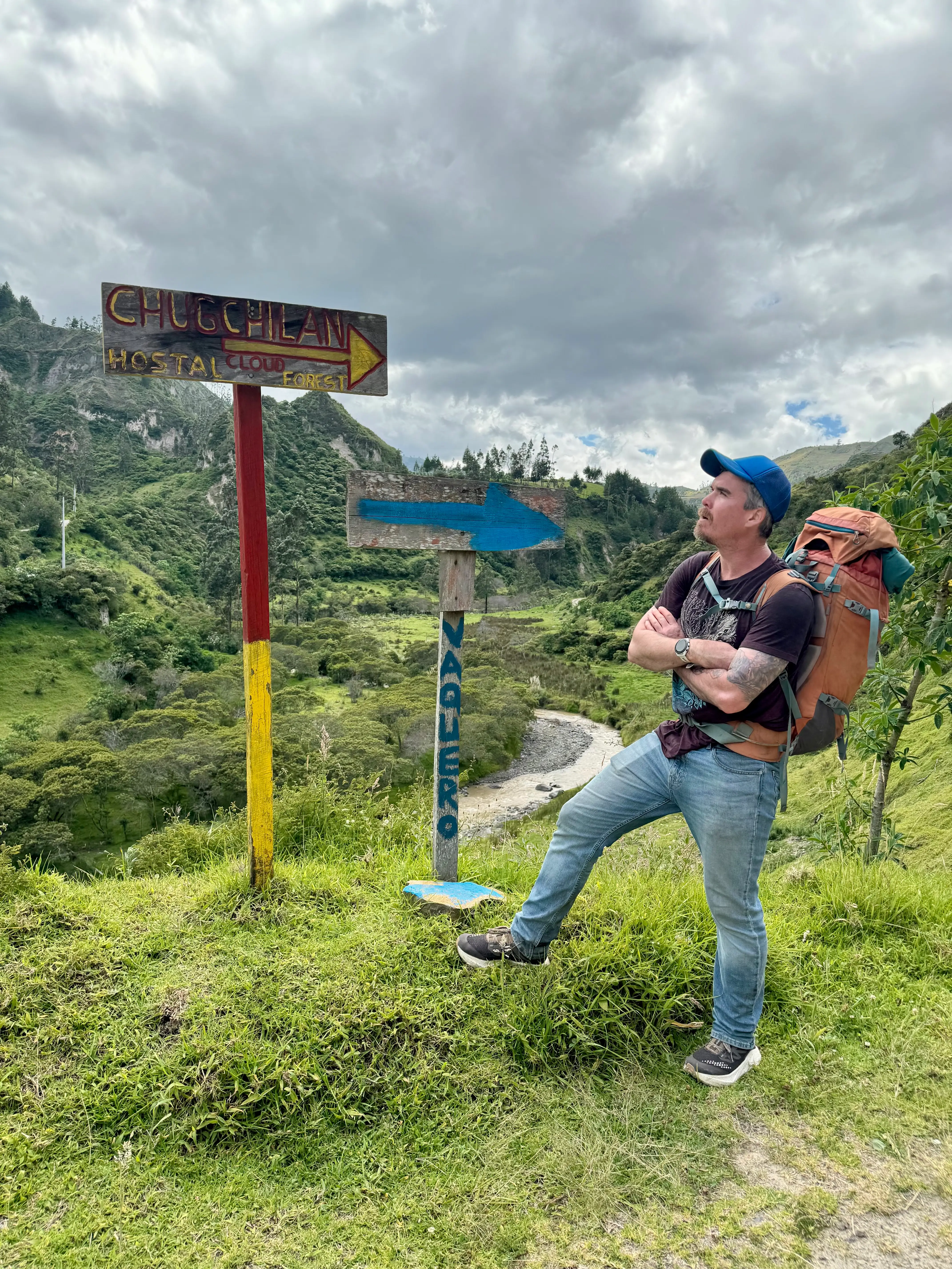 A man reading signs in Spanish during a hike in Ecuador.