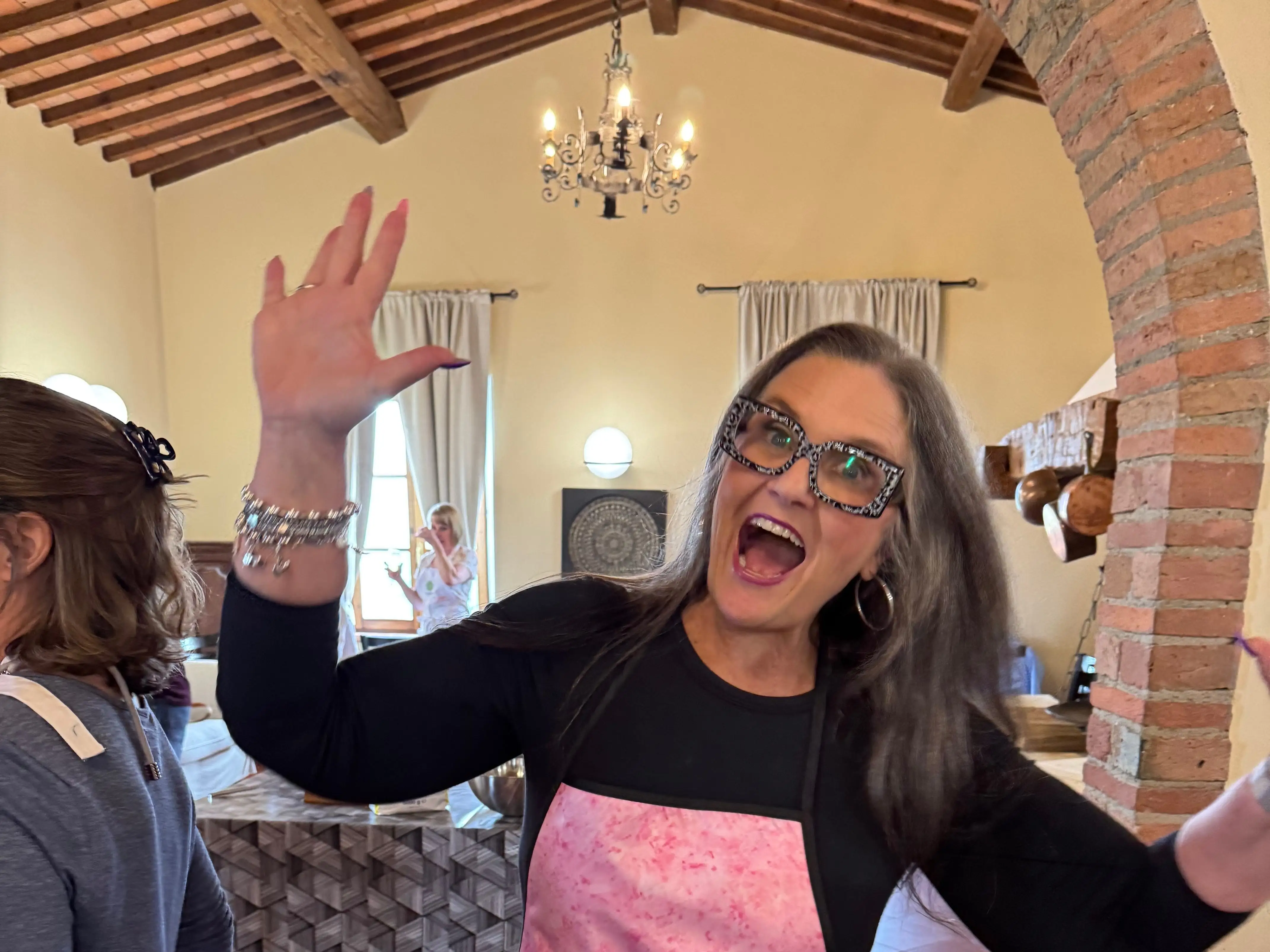 A woman wearing a pink apron.