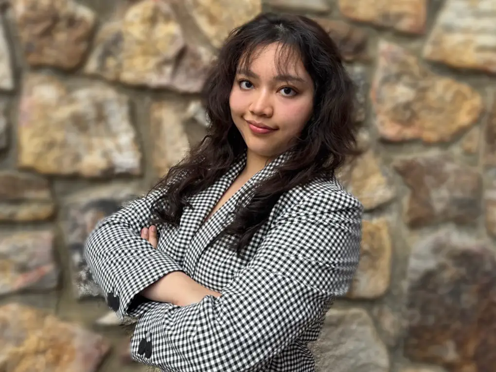 Vivienne Hnin standing with arms crossed