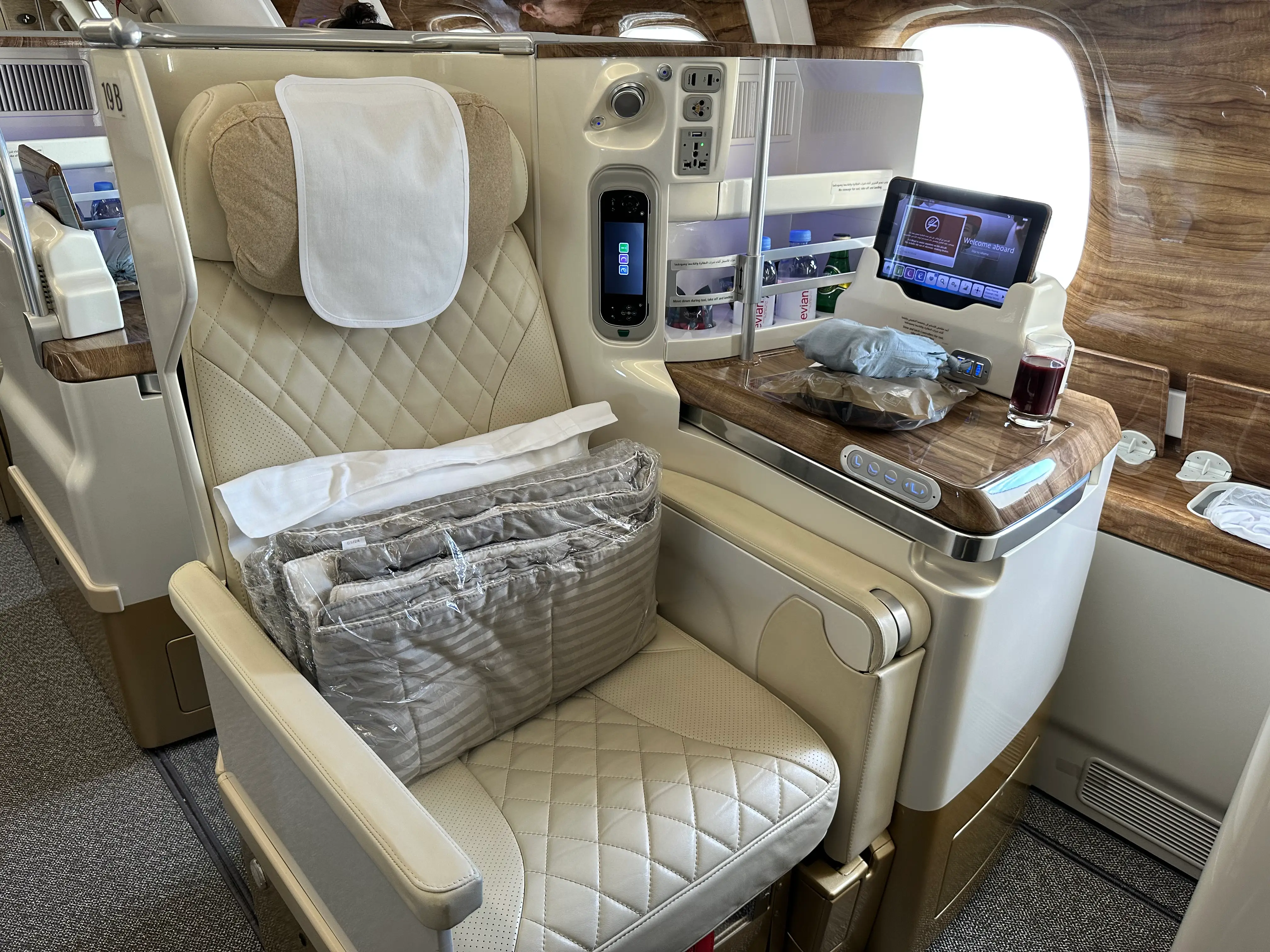 A business class seat with bedding.