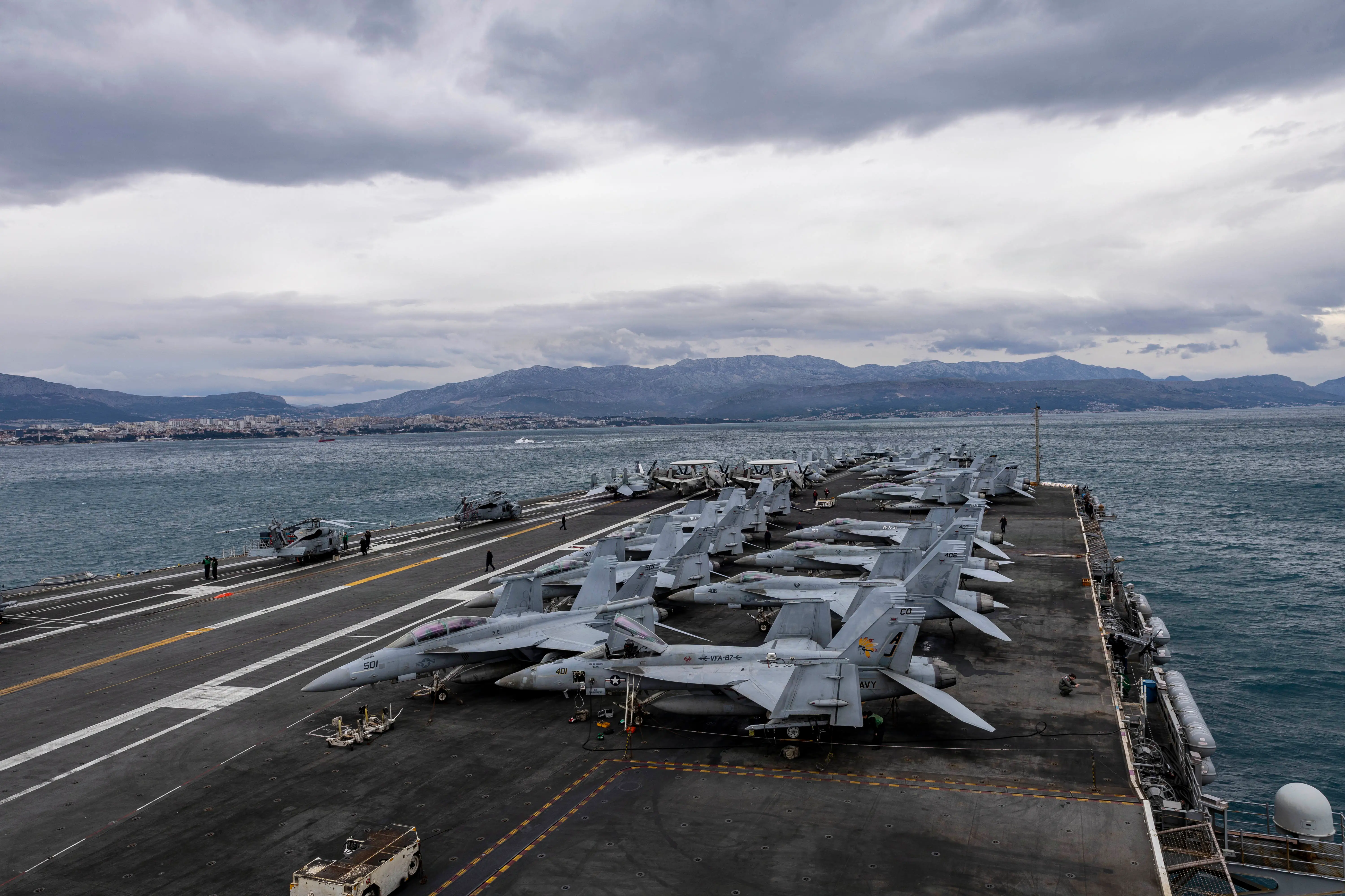 The US Navy Gerald R. Ford aircraft carrier's top deck with aircraft parked.