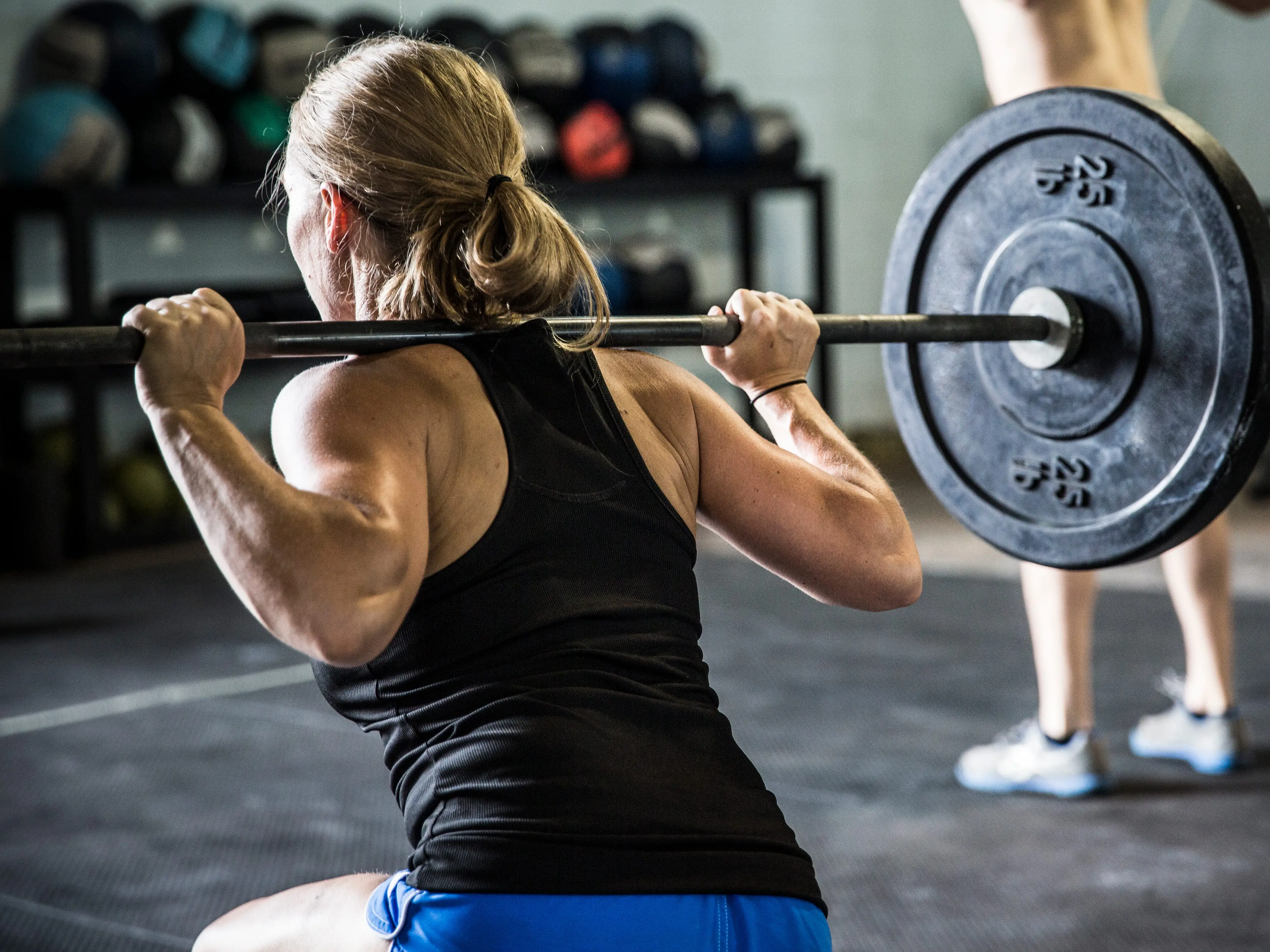 Woman back-squatting