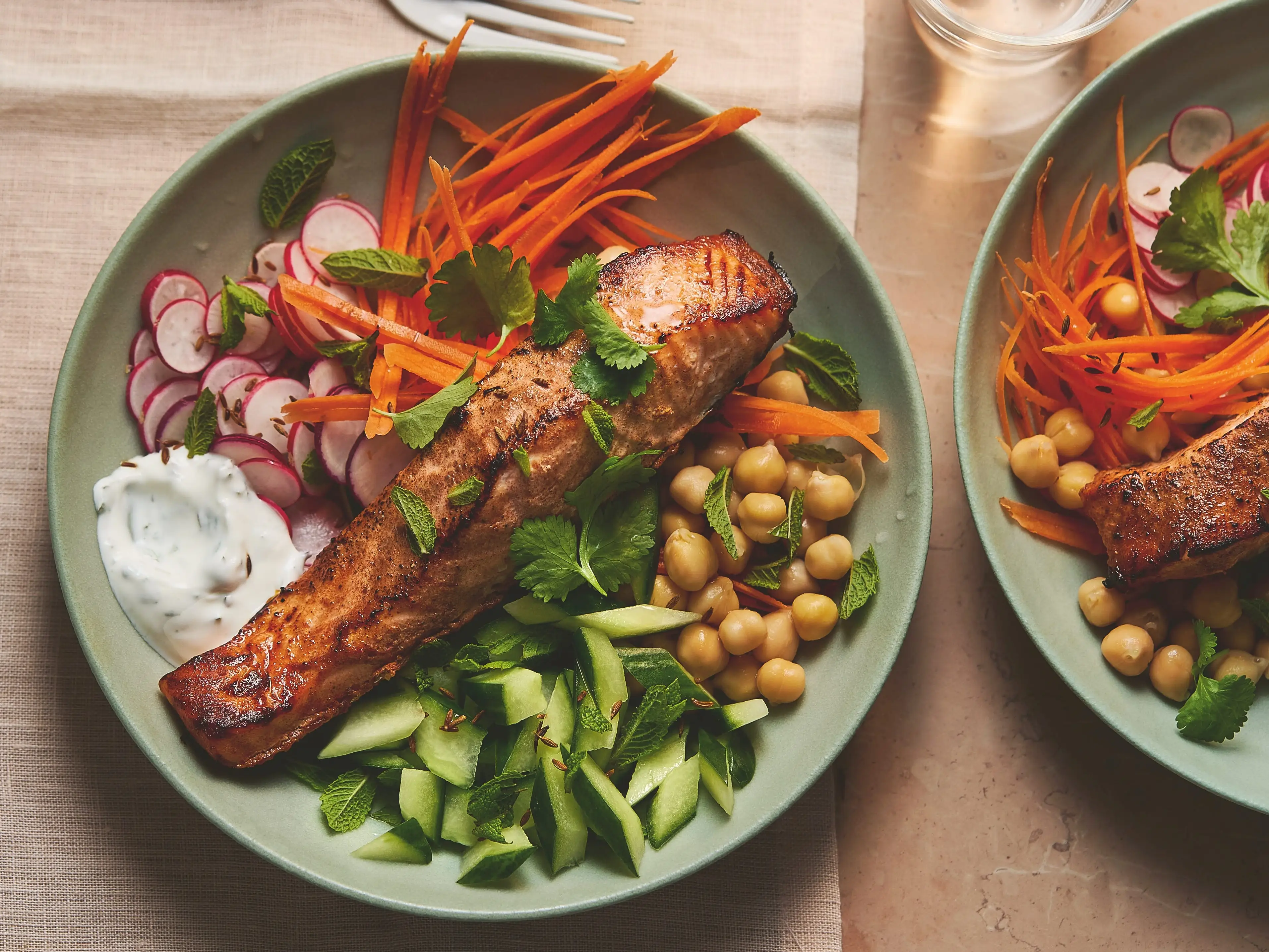 A bowl of baked salmon and veggies.