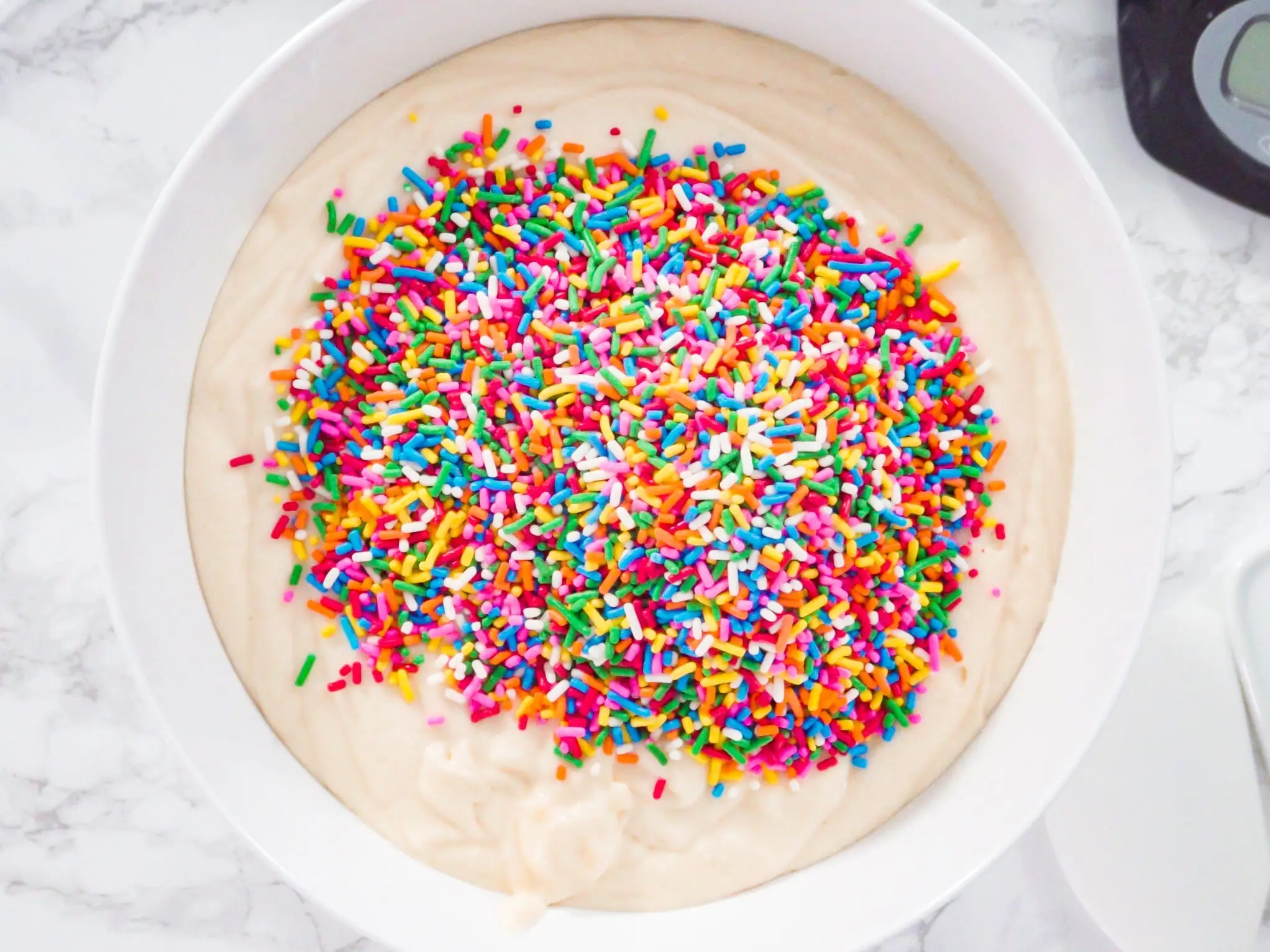 rainbow sprinkles in white cake batter