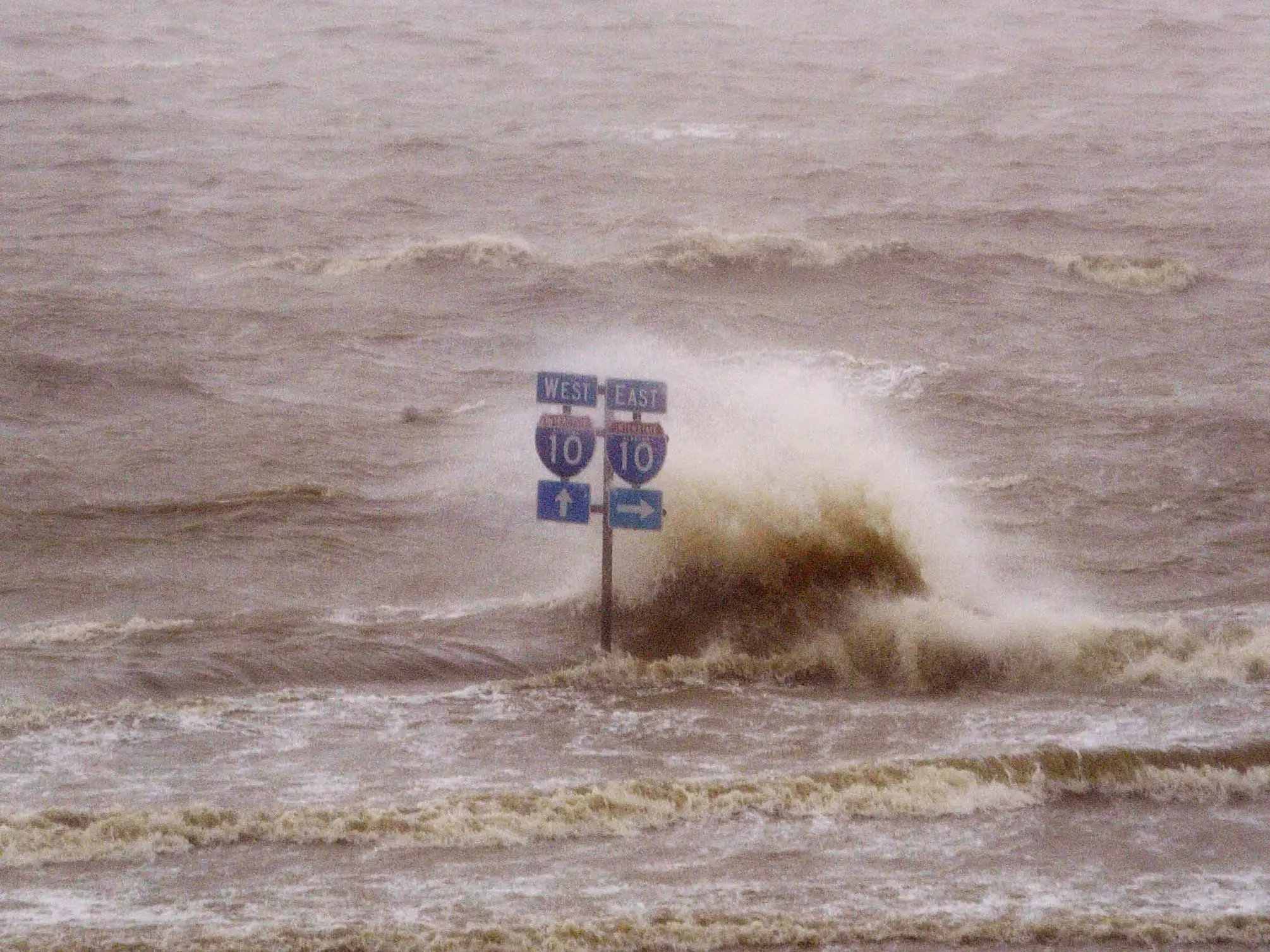 A sign directing drivers to the on ramp for Highway 10 sits half submerged in flood waters from the Gulf of Mexico after Hurricane Ivan passed through early September 16, 2004 in Mobile, Alabama.