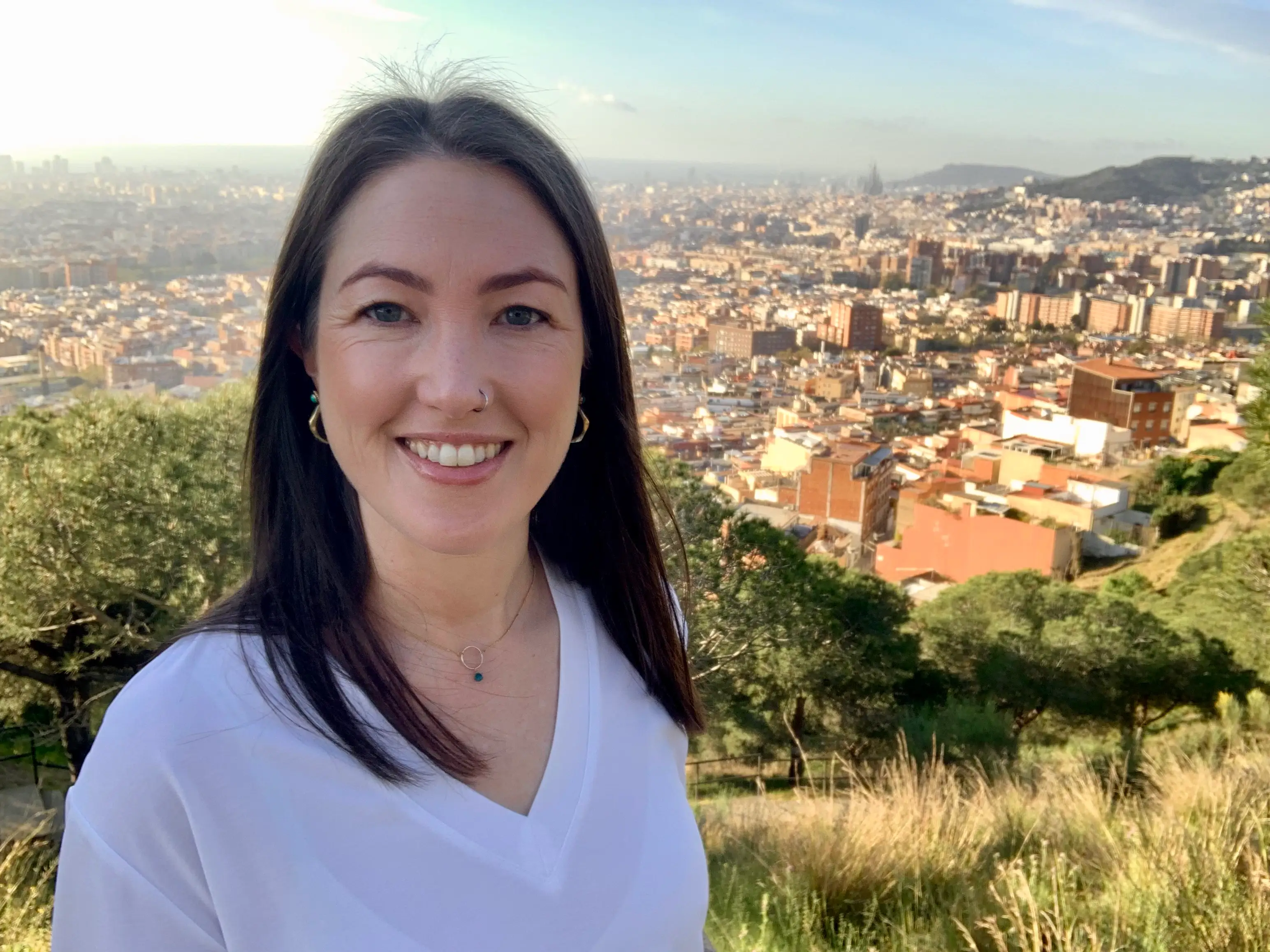 The author poses on a vista overlooking a city.