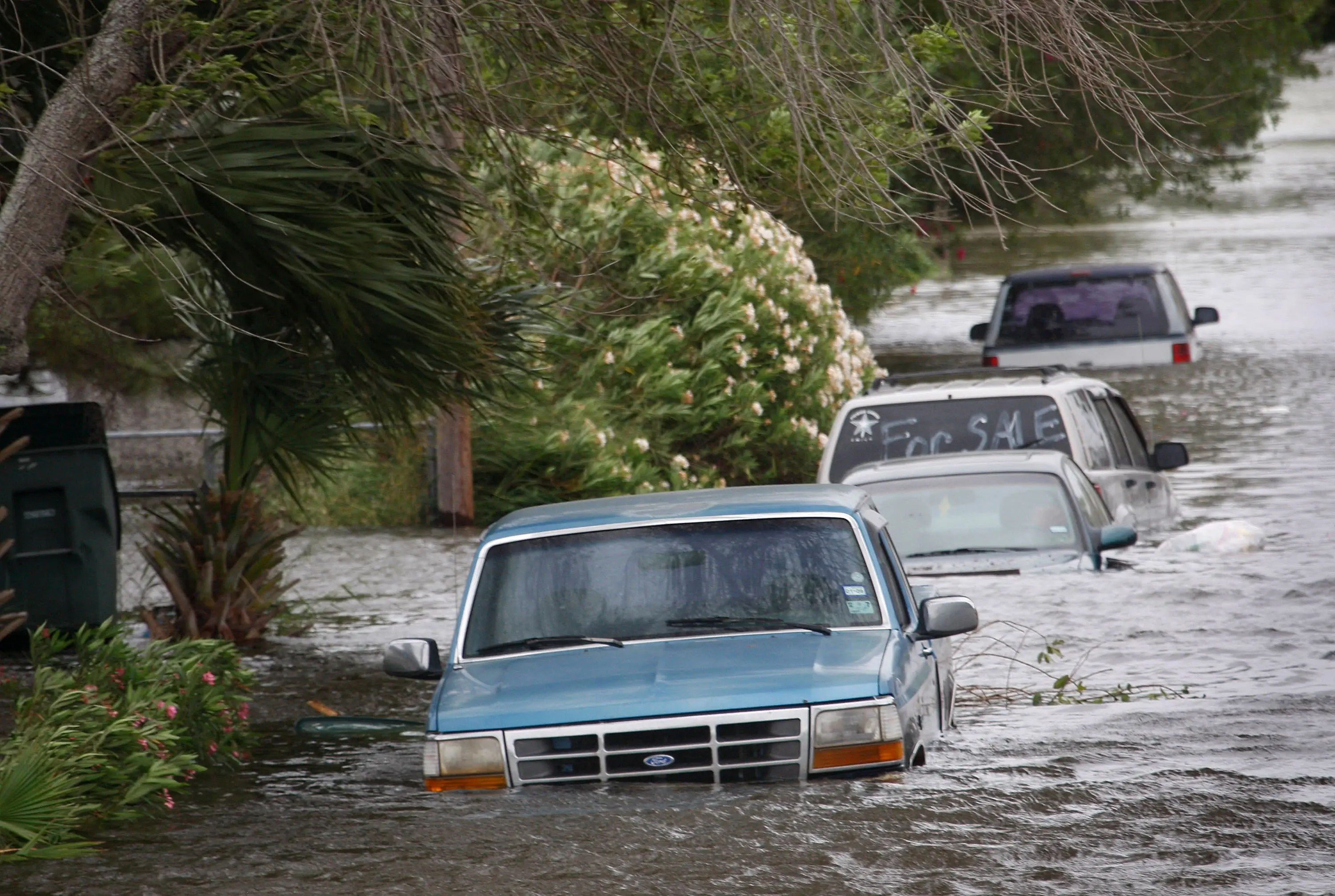 Vehicles flooded by the tidal surge from Hurricane Ike sit along a street September 12, 2008 in Galveston, Texas.
