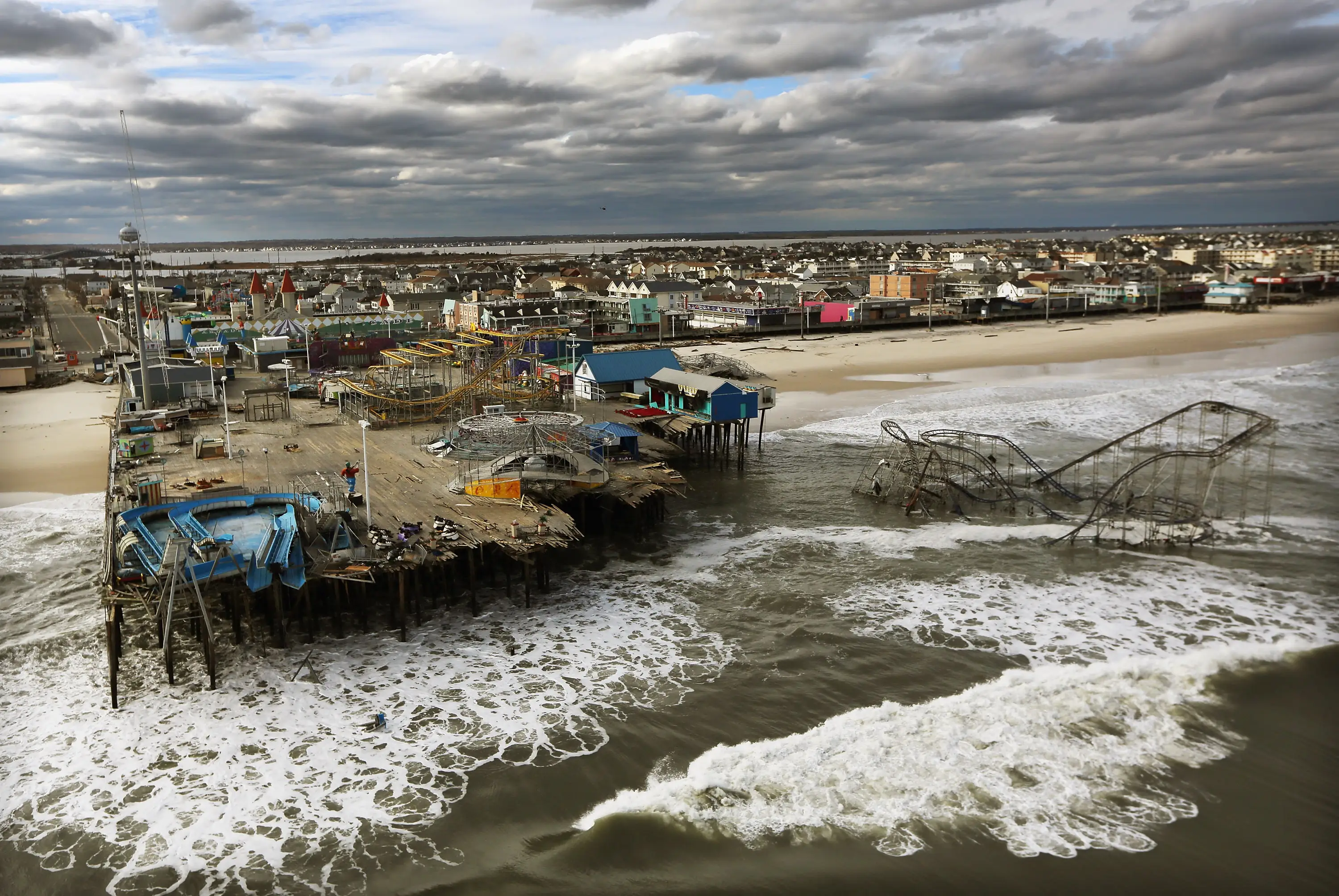 Waves break in front of a destroyed amusement park wrecked by Hurricane Sandy on October 31, 2012 in Seaside Heights, New Jersey.