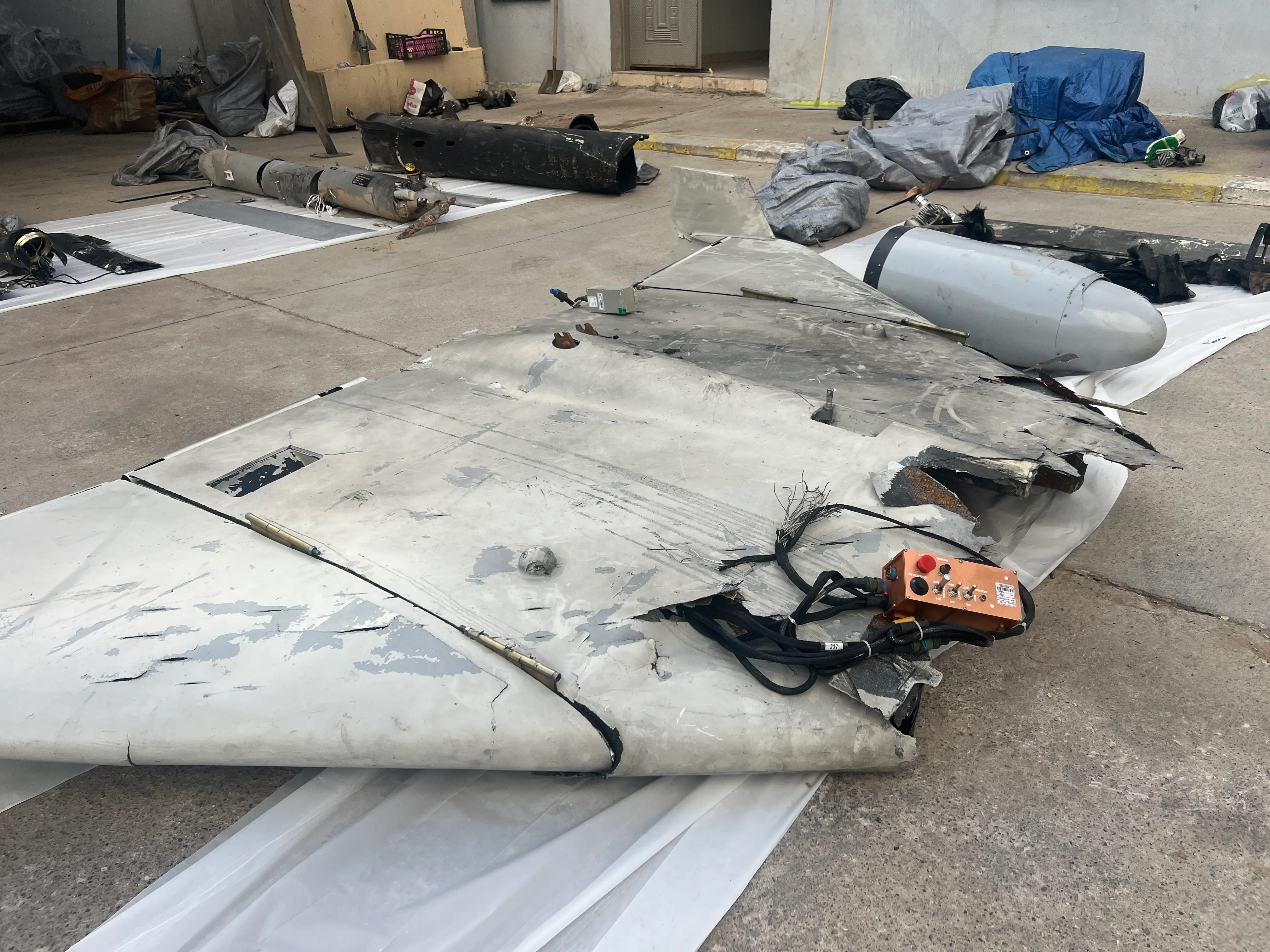 Kurdish officials displayed the remnants of a Shahed drone (foreground) they recovered from an Iranian attack.