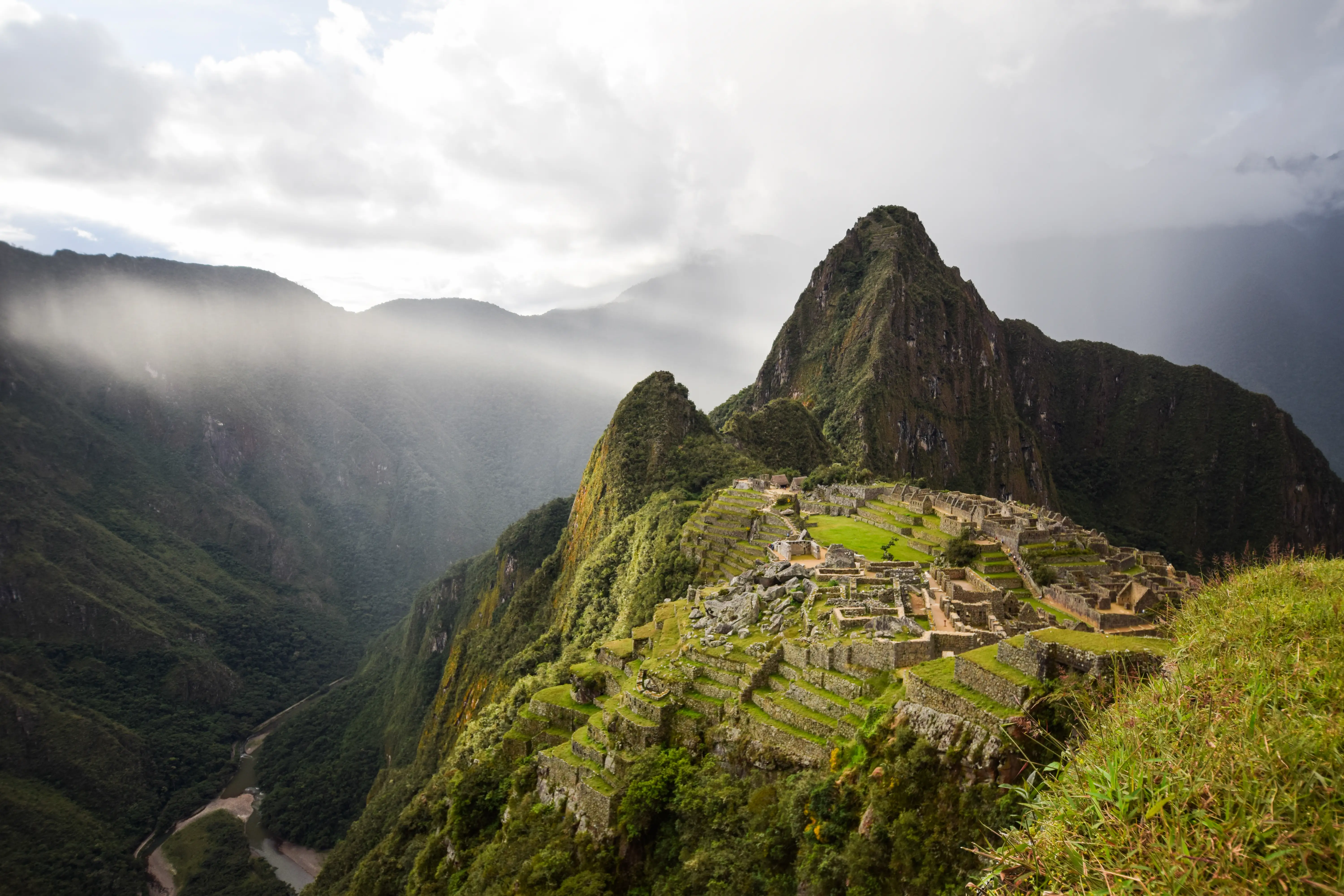Moss-covered mountain area with fog above mountains