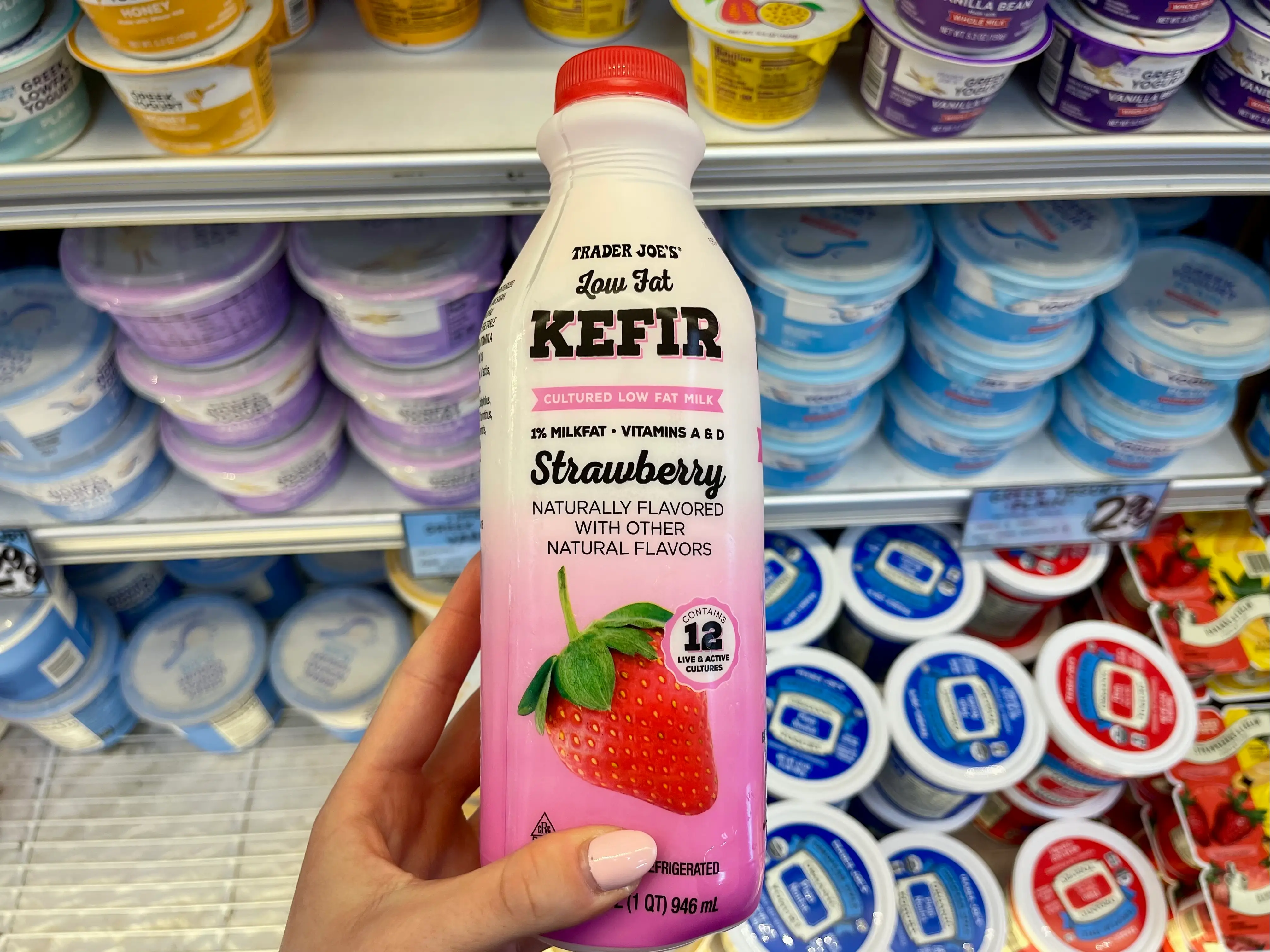 Serena holds a bottle of Trader Joe's low-fat strawberry kefir.