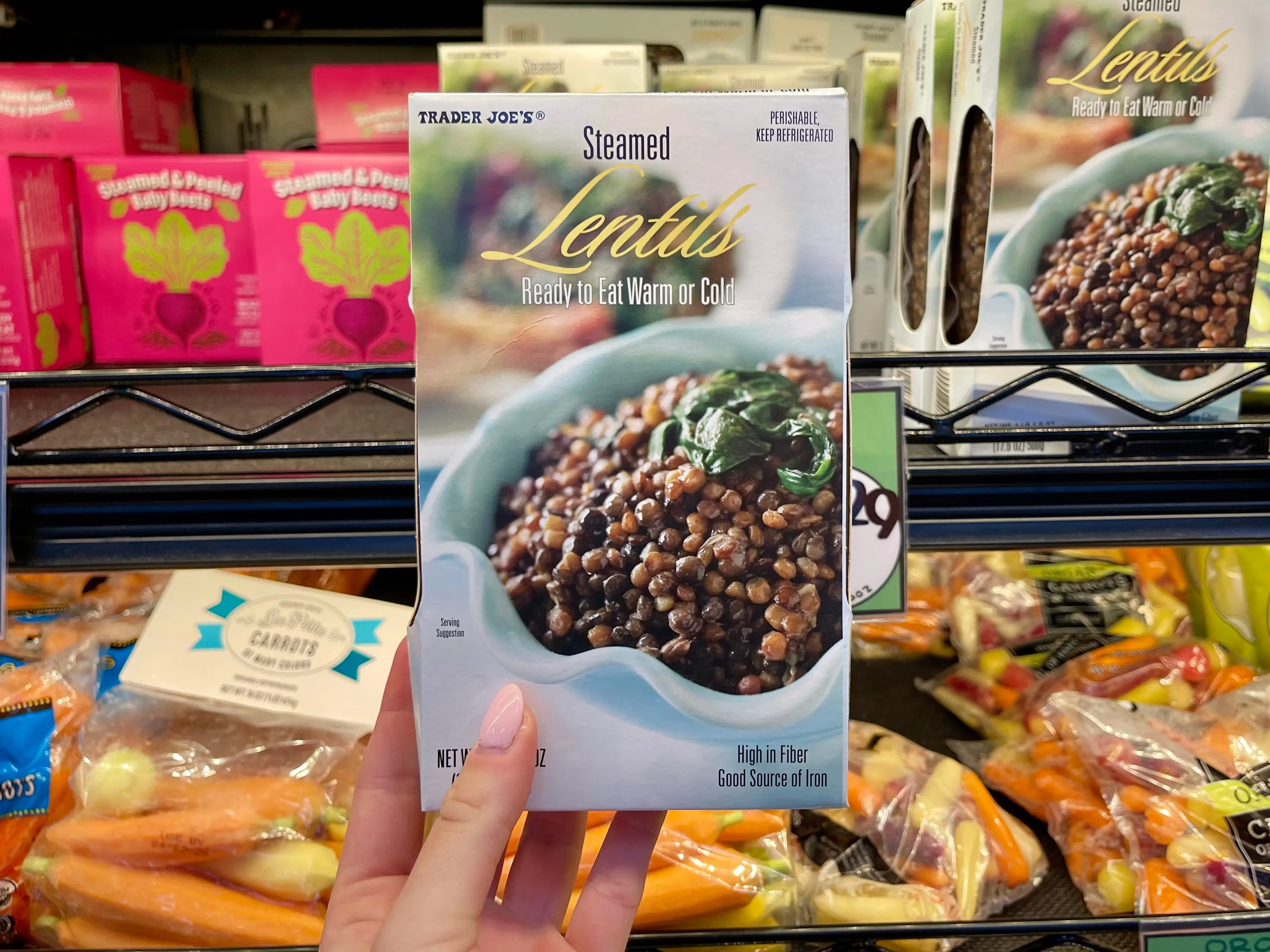 Serena holds a box of Trader Joe's steamed lentils.