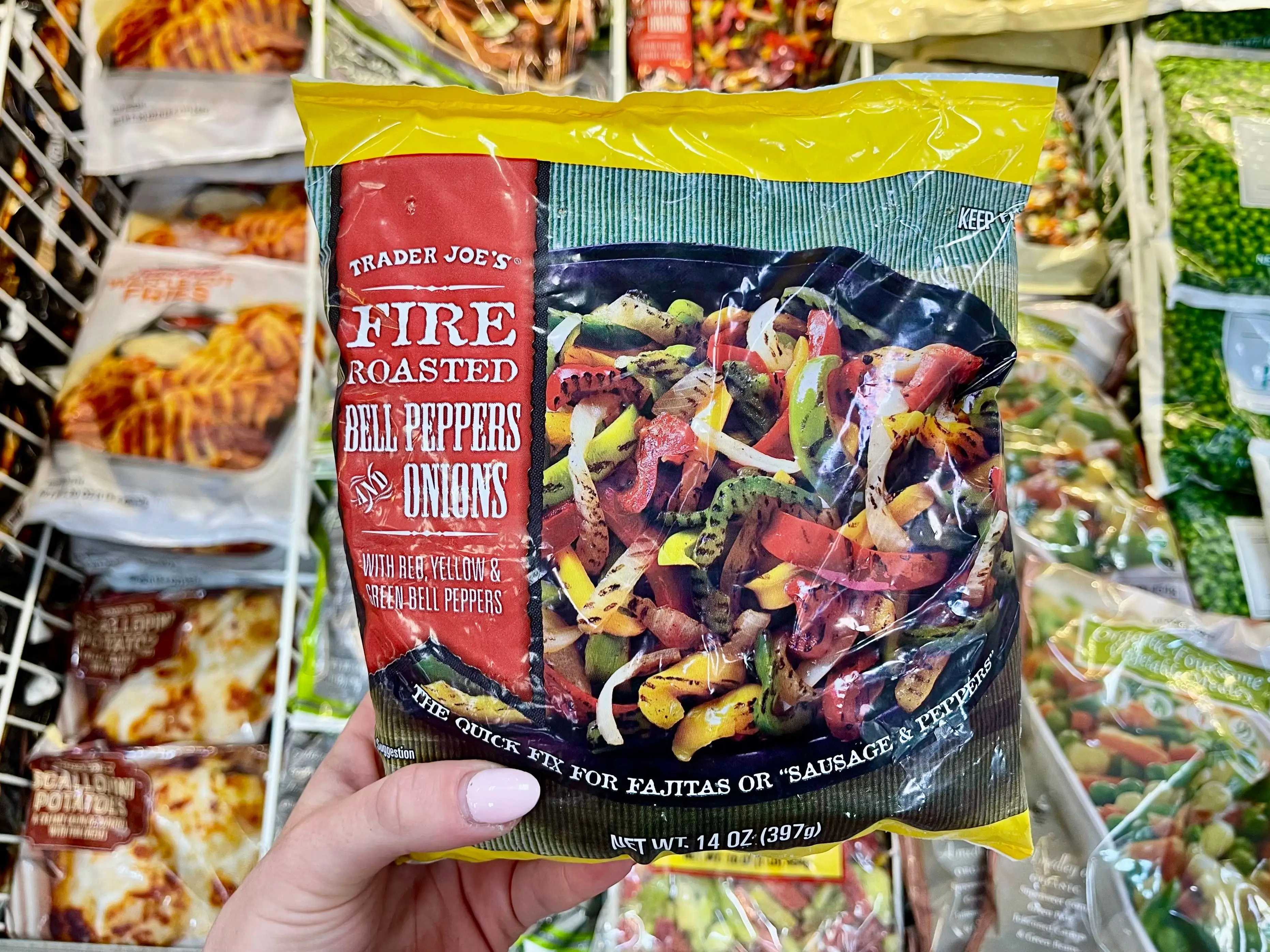 Serena holds a bag of Trader Joe's fire-roasted bell peppers and onions.