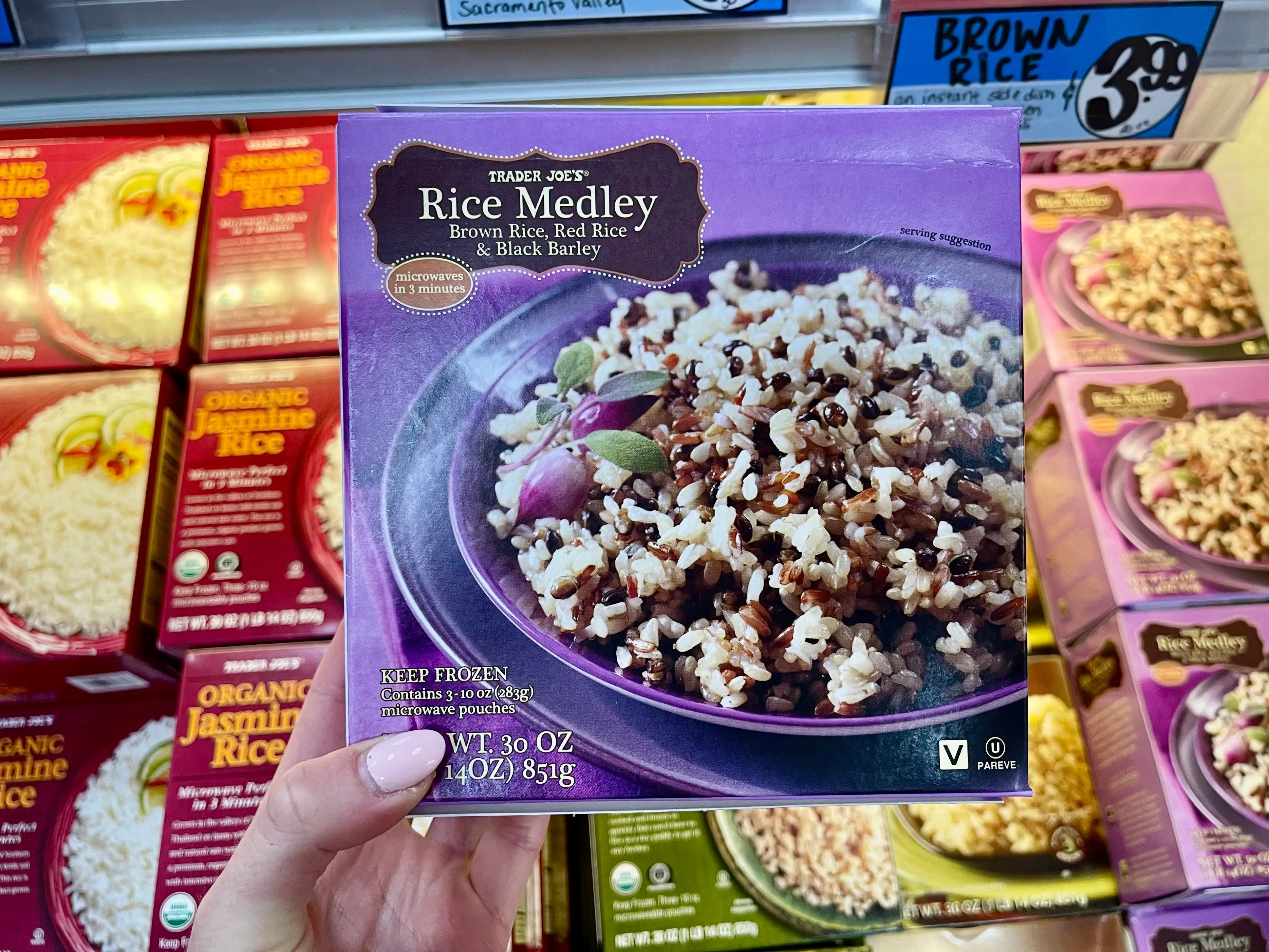 Serena holds a box of Trader Joe's rice medley.