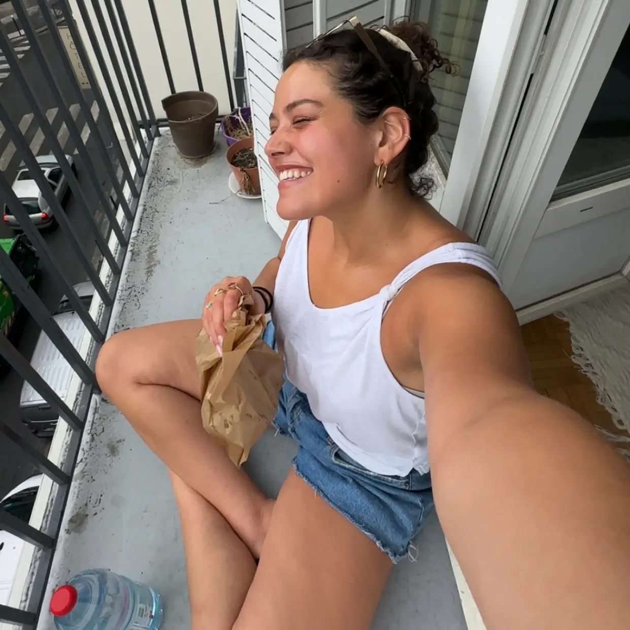 Woman smiling sitting on balcony